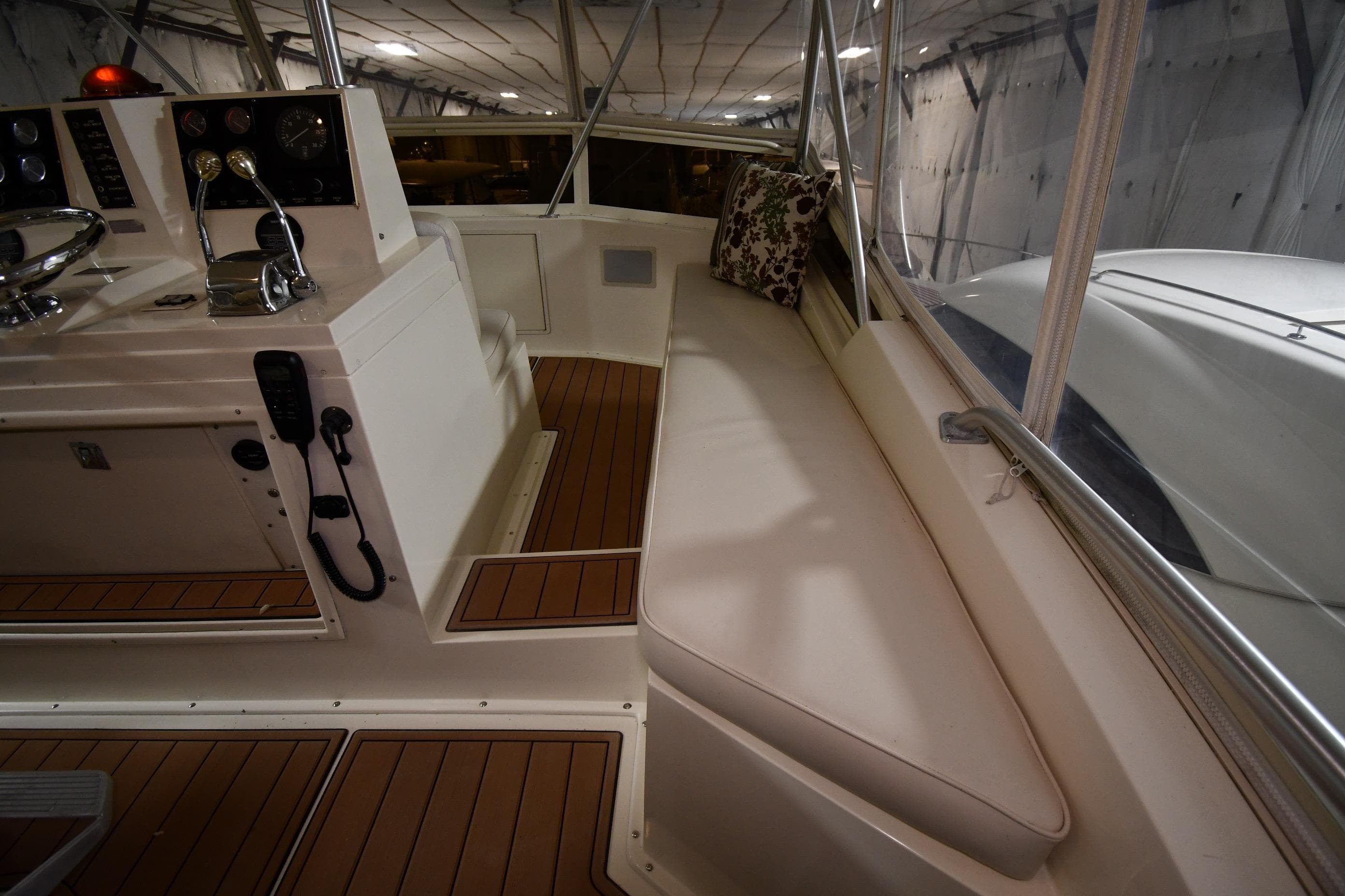 1988 Viking 48 Convertible yacht interior with helm and cushioned seating.