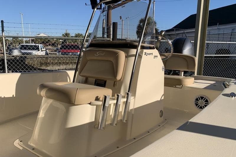 2025 Scout 177 Sport boat interior with beige seating and steering console.