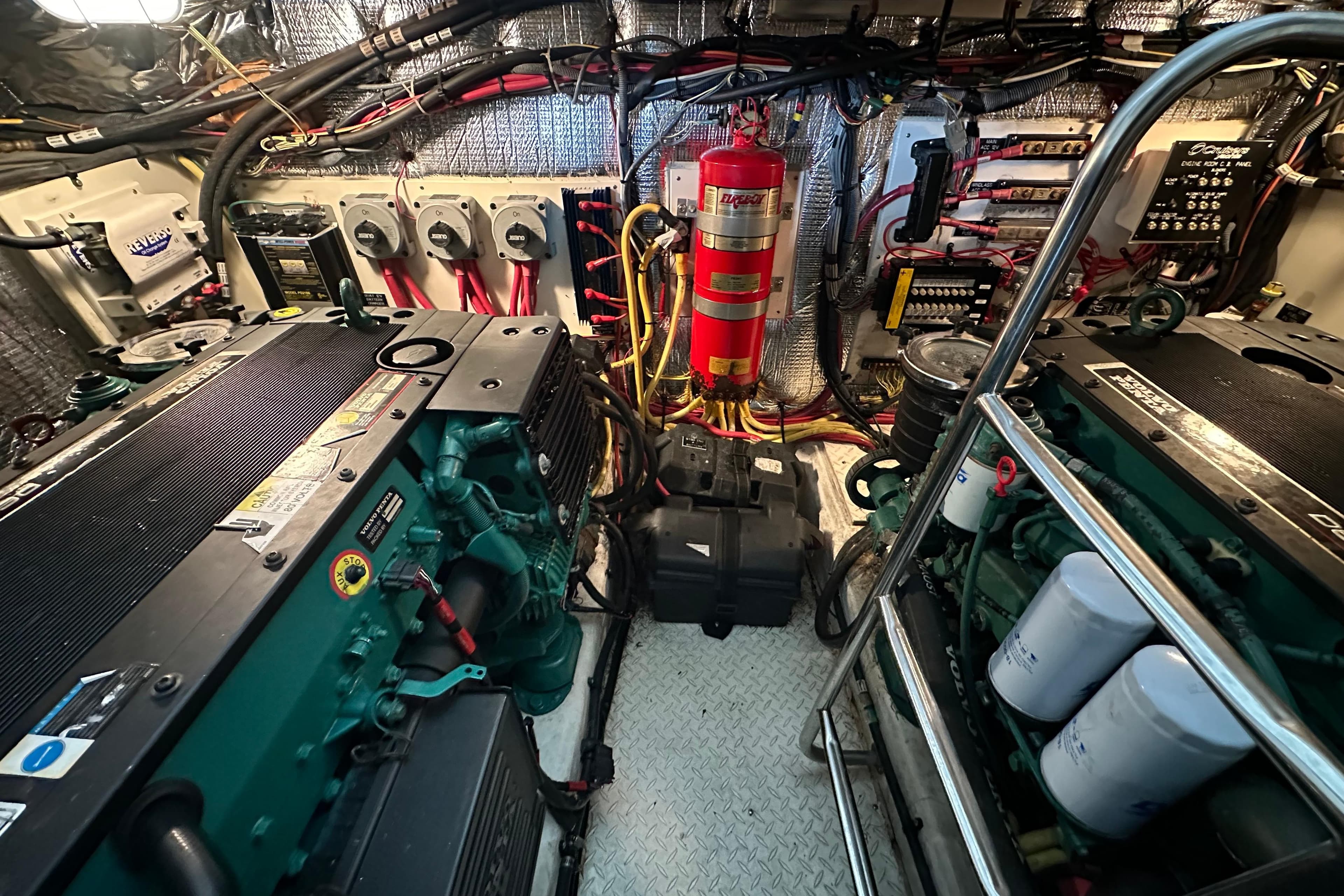 Engine room of 2005 Cruisers Yachts 400 Express with visible machinery and wiring.