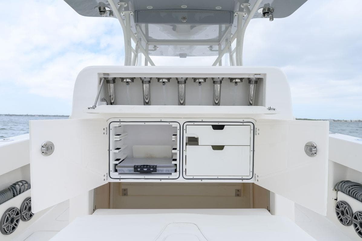 2024 SeaVee 370Z boat storage compartments open, showcasing organized interior space.