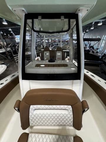 2025 Pioneer Pelagic 270 boat interior with brown and white seating, showroom display.