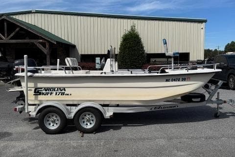 2006 Carolina Skiff 178 DLX boat on trailer, parked outdoors.