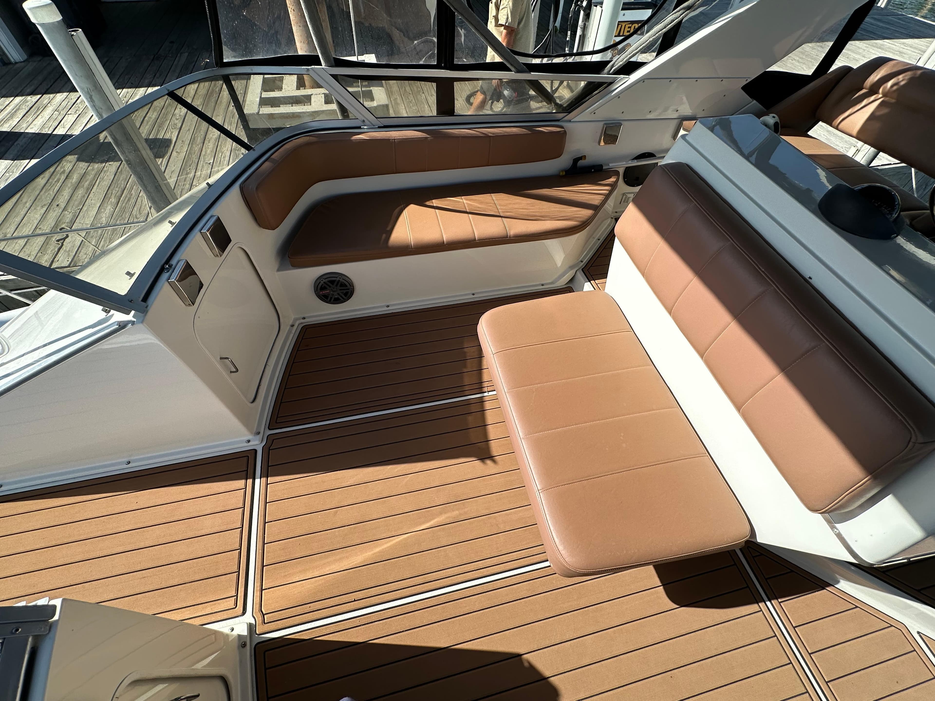 1996 Carver 38 Santego boat interior with brown seating and wood-patterned flooring.