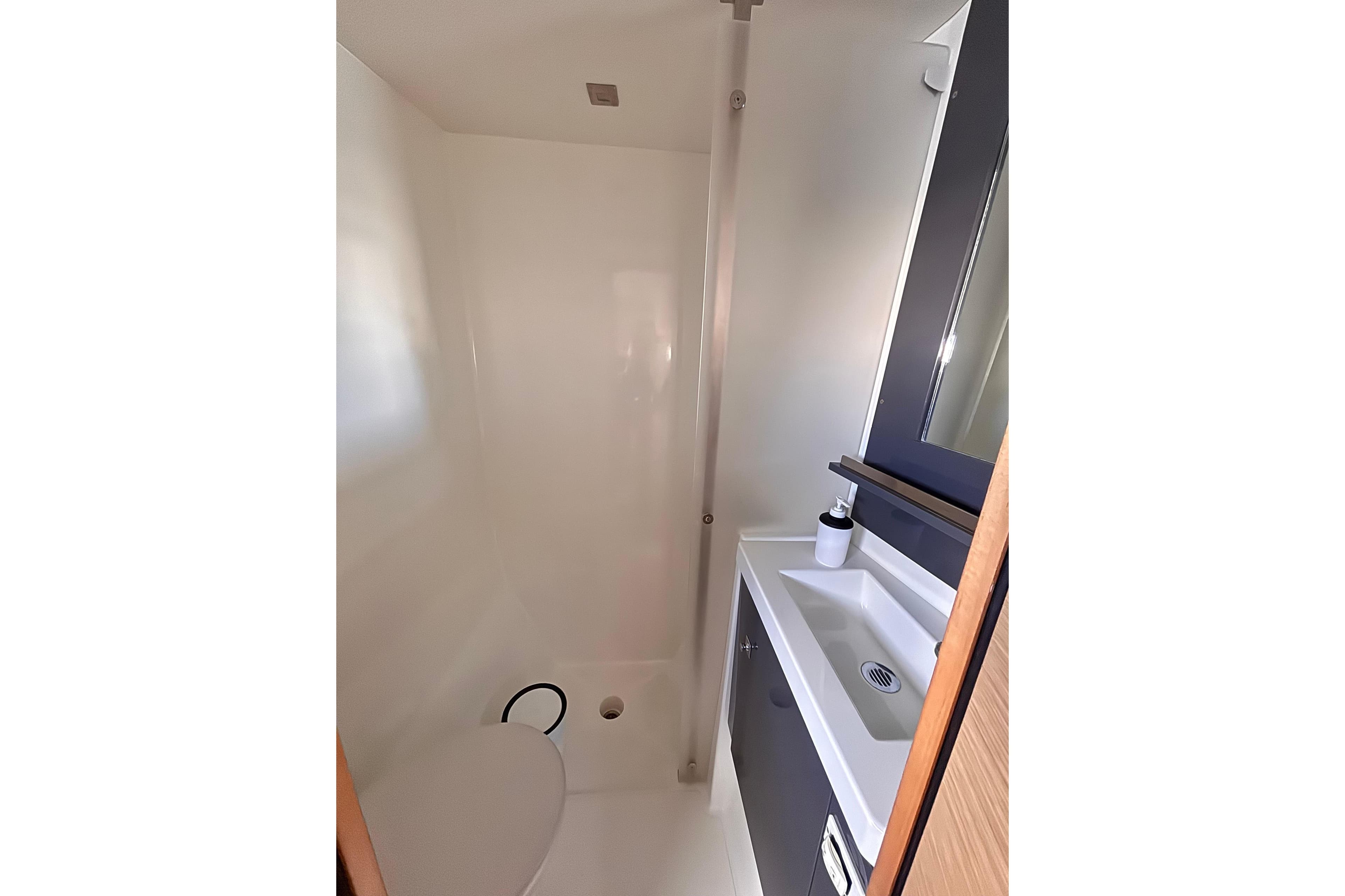 Bathroom interior of 2016 Fountaine Pajot SABA 50 yacht, featuring modern sink and toilet.