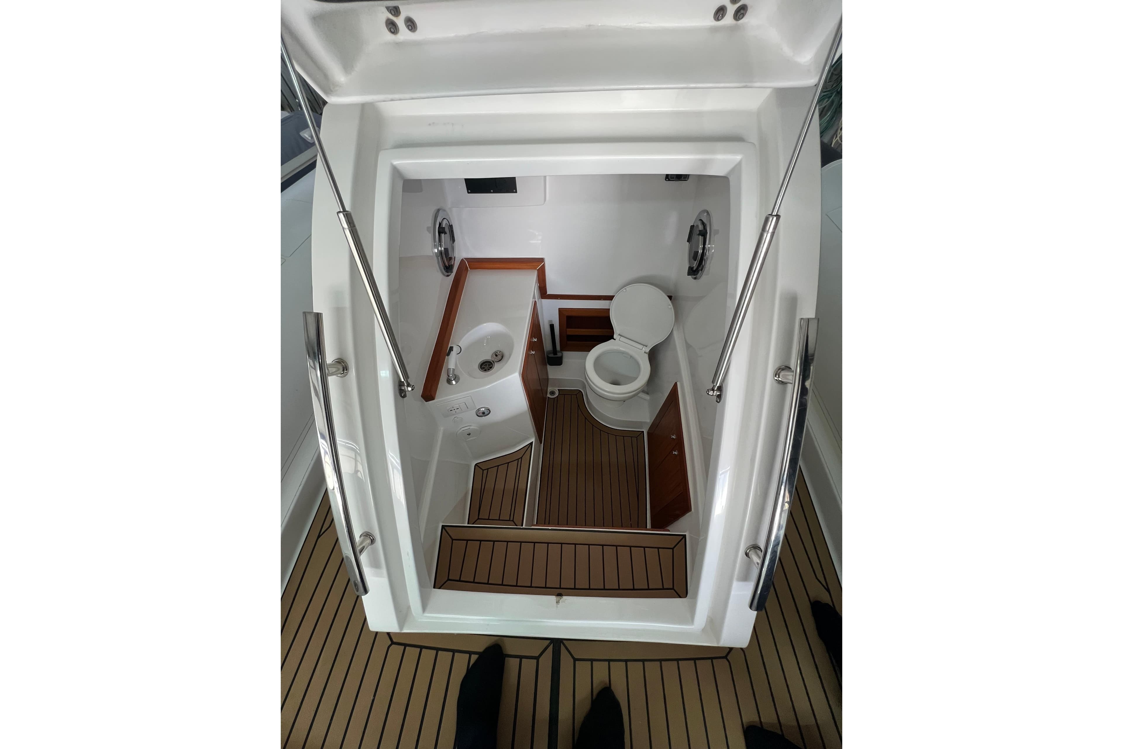 Interior of 2021 Novamares 31 Extreme boat, featuring a compact bathroom with wooden accents.