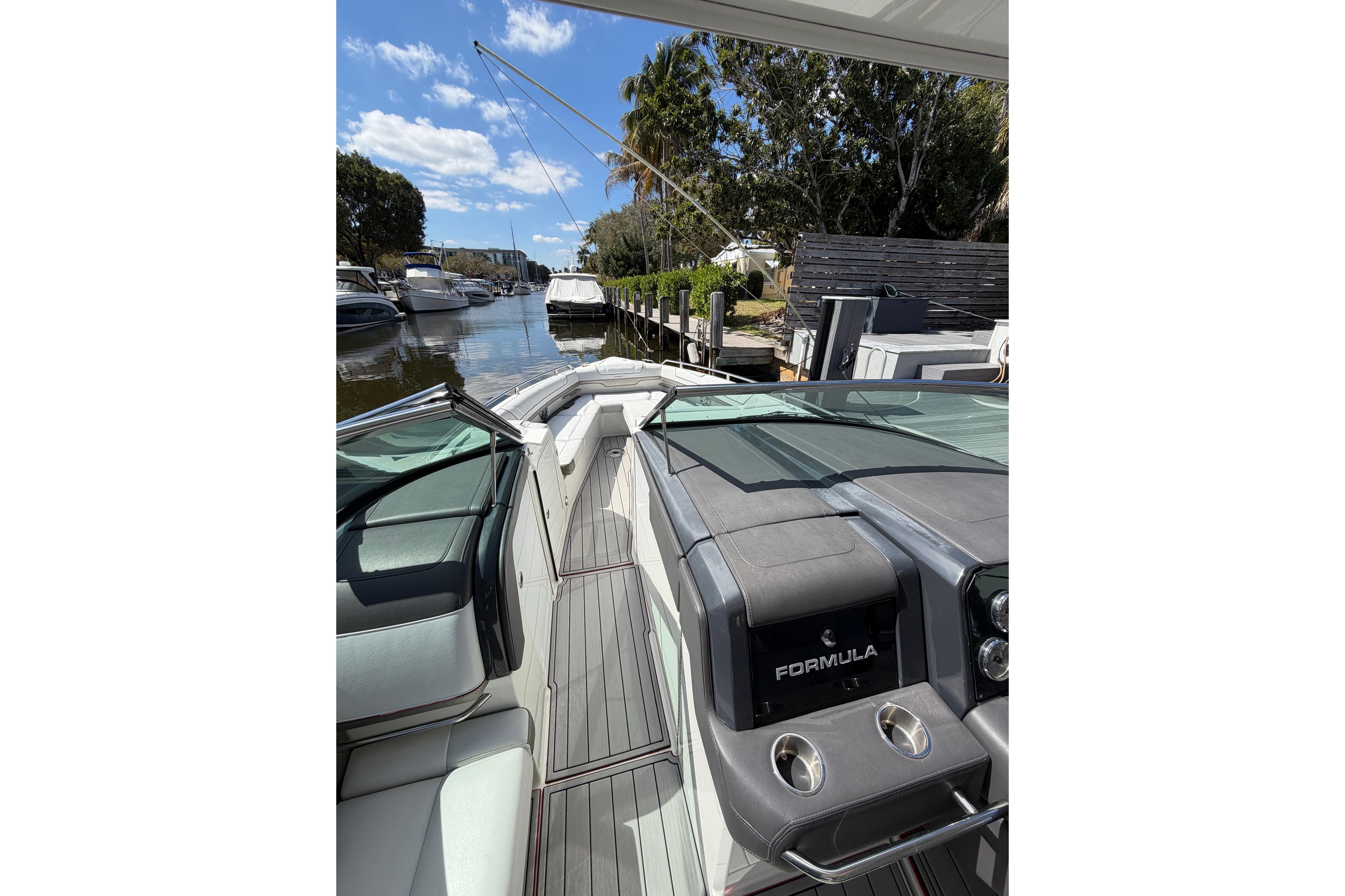 2020 Formula 330 Crossover Bowrider OB interior, docked in a scenic marina.