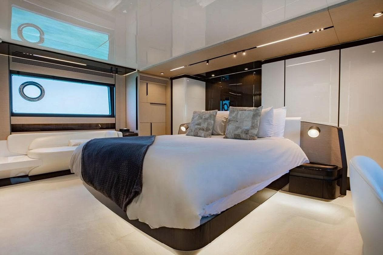 Luxurious bedroom interior of 2022 Azimut S10 yacht with modern design and elegant furnishings.