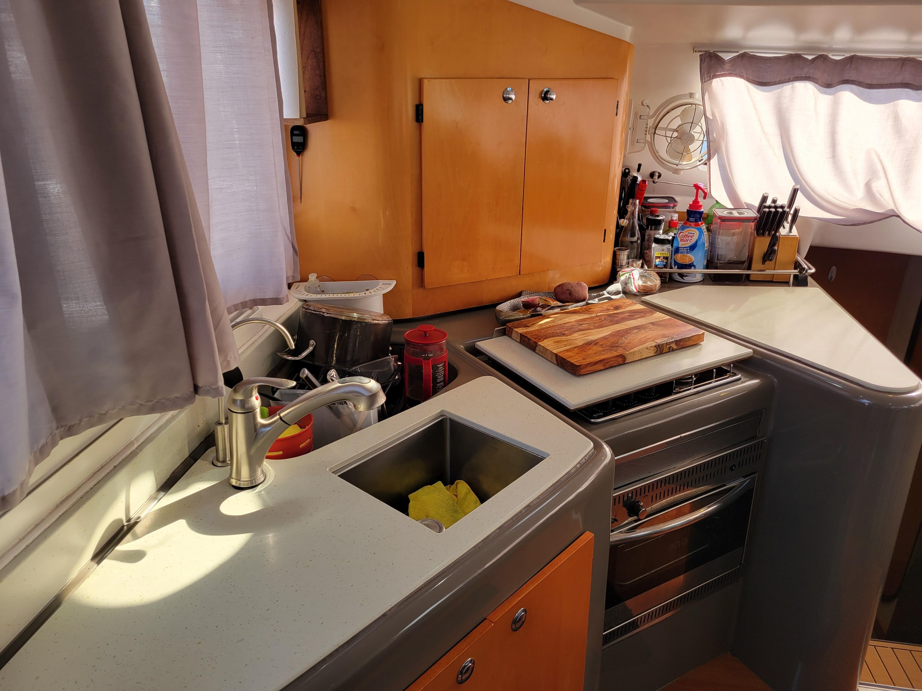 2006 Fountaine Pajot LAVEZZI yacht kitchen with modern appliances and wooden cabinetry.
