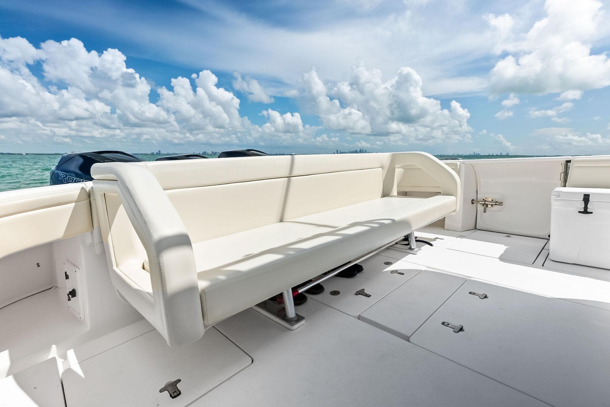 2018 Intrepid 430 Sport Yacht deck with seating, ocean view, and clear skies.
