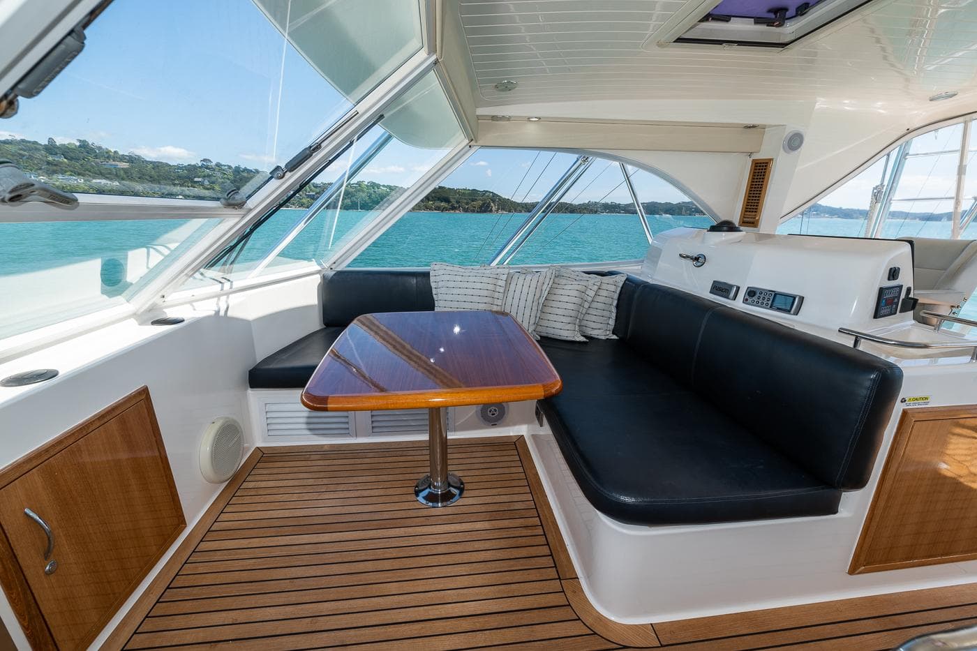 2009 Maritimo 500 Offshore yacht interior with seating and table, overlooking scenic ocean view.
