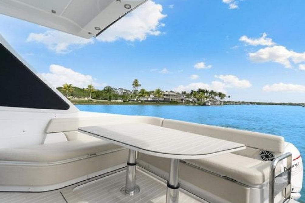 2023 Azimut Verve 42 yacht deck with seating, table, and scenic ocean view.