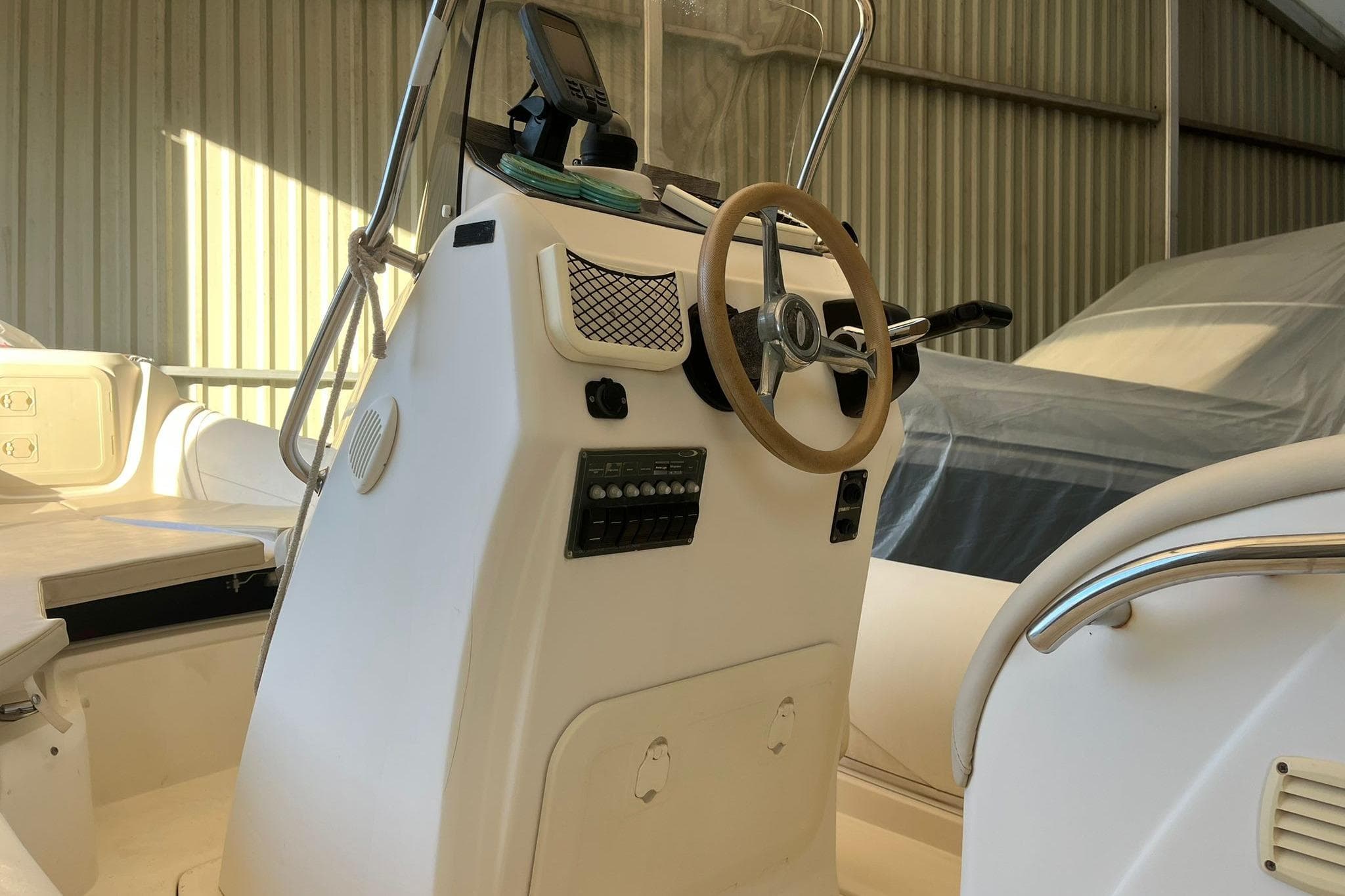 2011 Nuova Jolly Prince 23 boat interior with steering wheel and control panel.