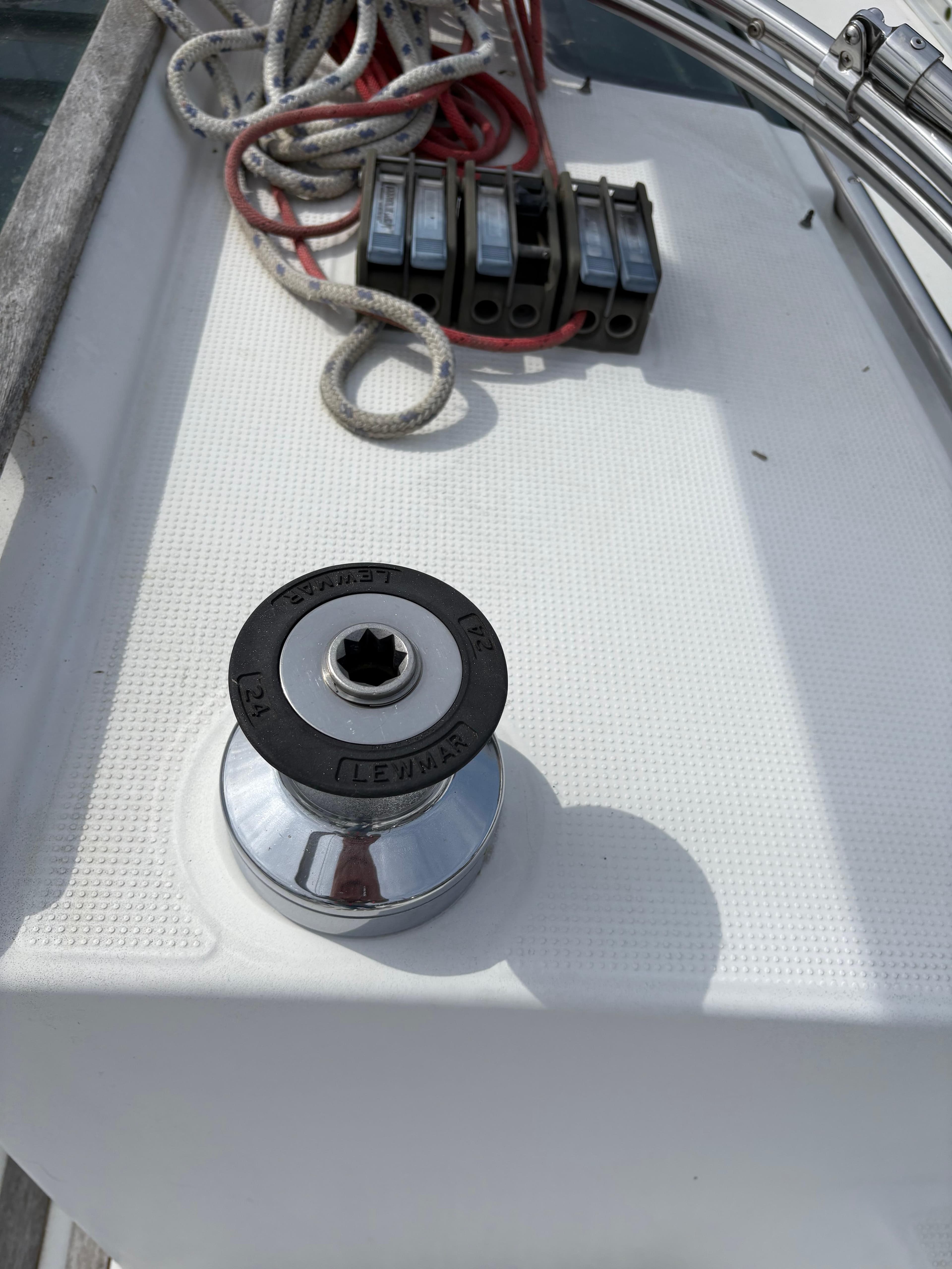 Winch and ropes on a 1989 Beneteau 32s5 sailboat deck.