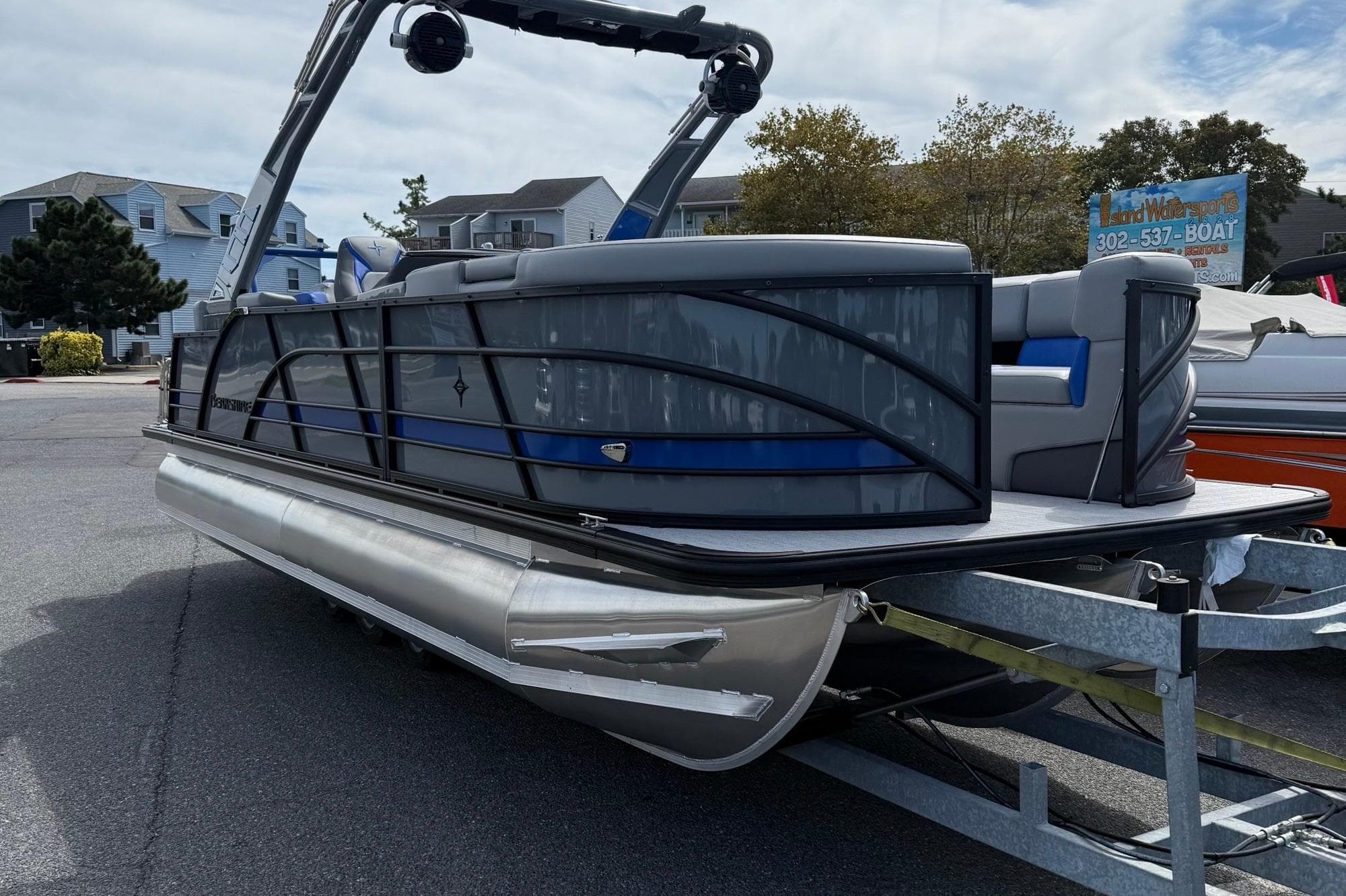 2026 Berkshire 23RFX STS pontoon boat on trailer, parked outdoors.
