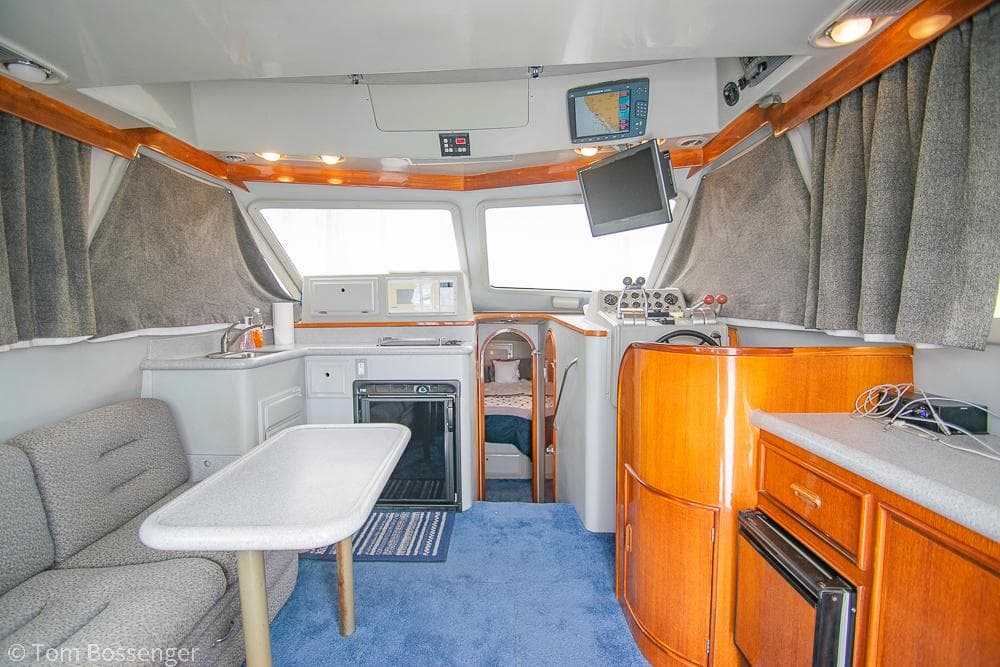 Interior of 1996 Mediterranean 38 Convertible yacht with modern amenities and cozy seating.