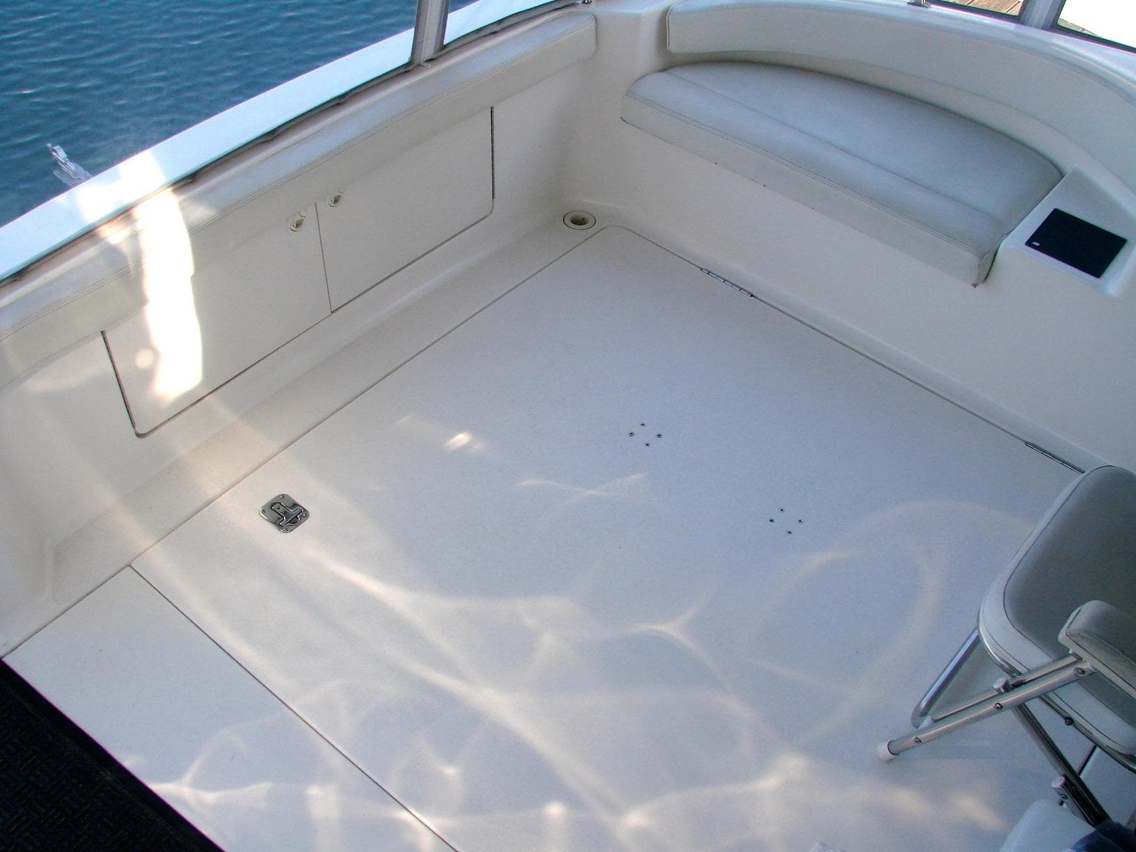Interior of a 1999 Silverton 351 Sedan yacht, white seating and floor.