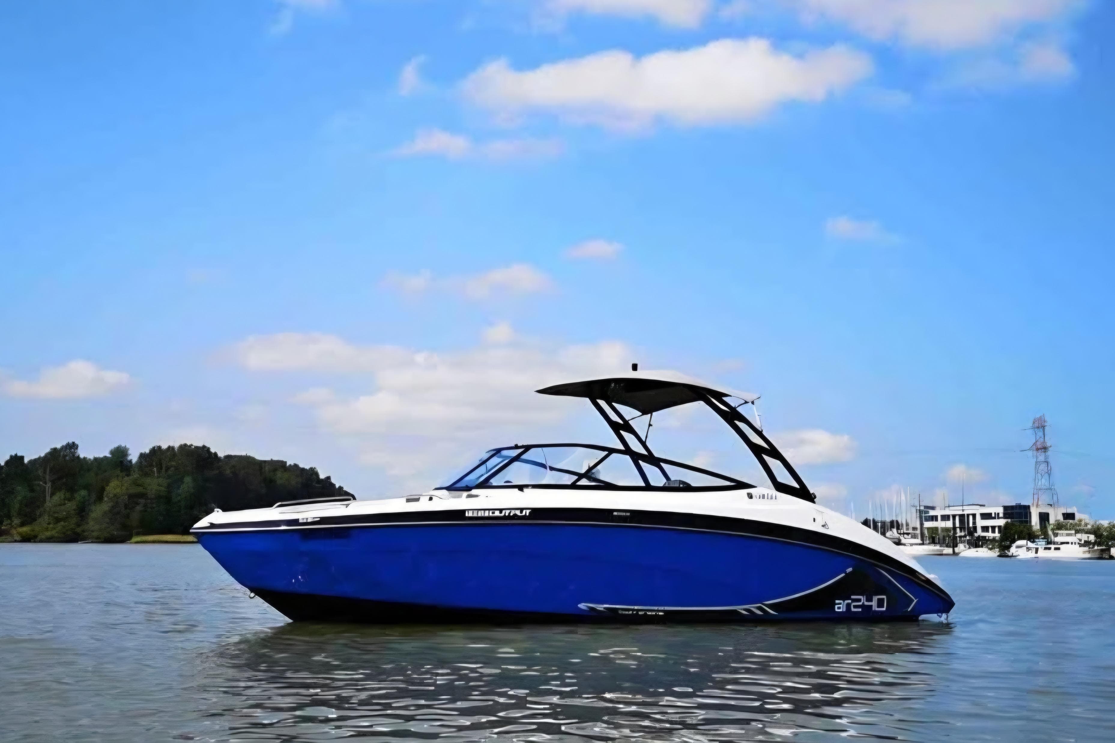 2015 Yamaha Boats AR240 HO on calm water under blue sky.