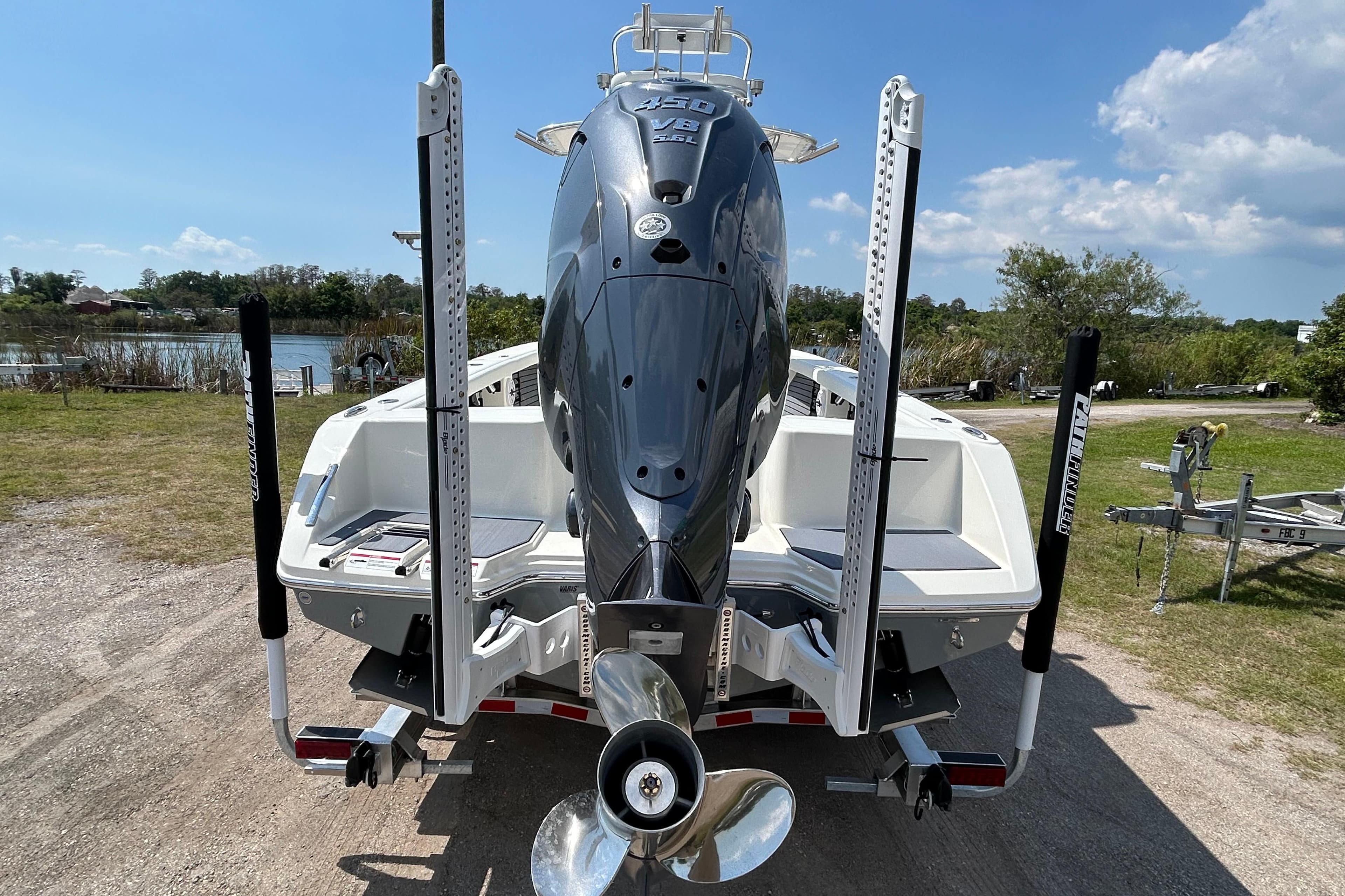2026 Pathfinder 2700 Open boat with powerful outboard motor, parked on a sunny day.