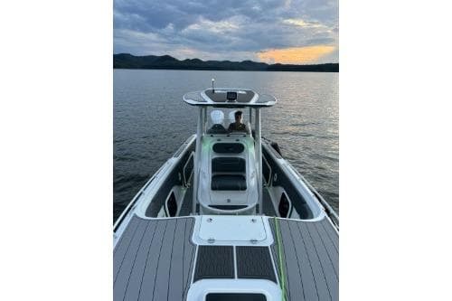 2023 Glasstream 328 SCX boat on serene lake at sunset.