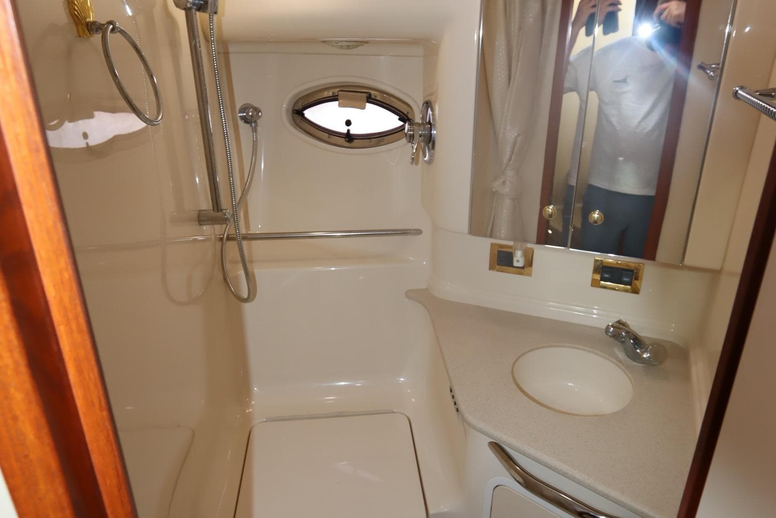 Bathroom interior of 2000 Sea Ray 460 Sundancer yacht with shower and sink.