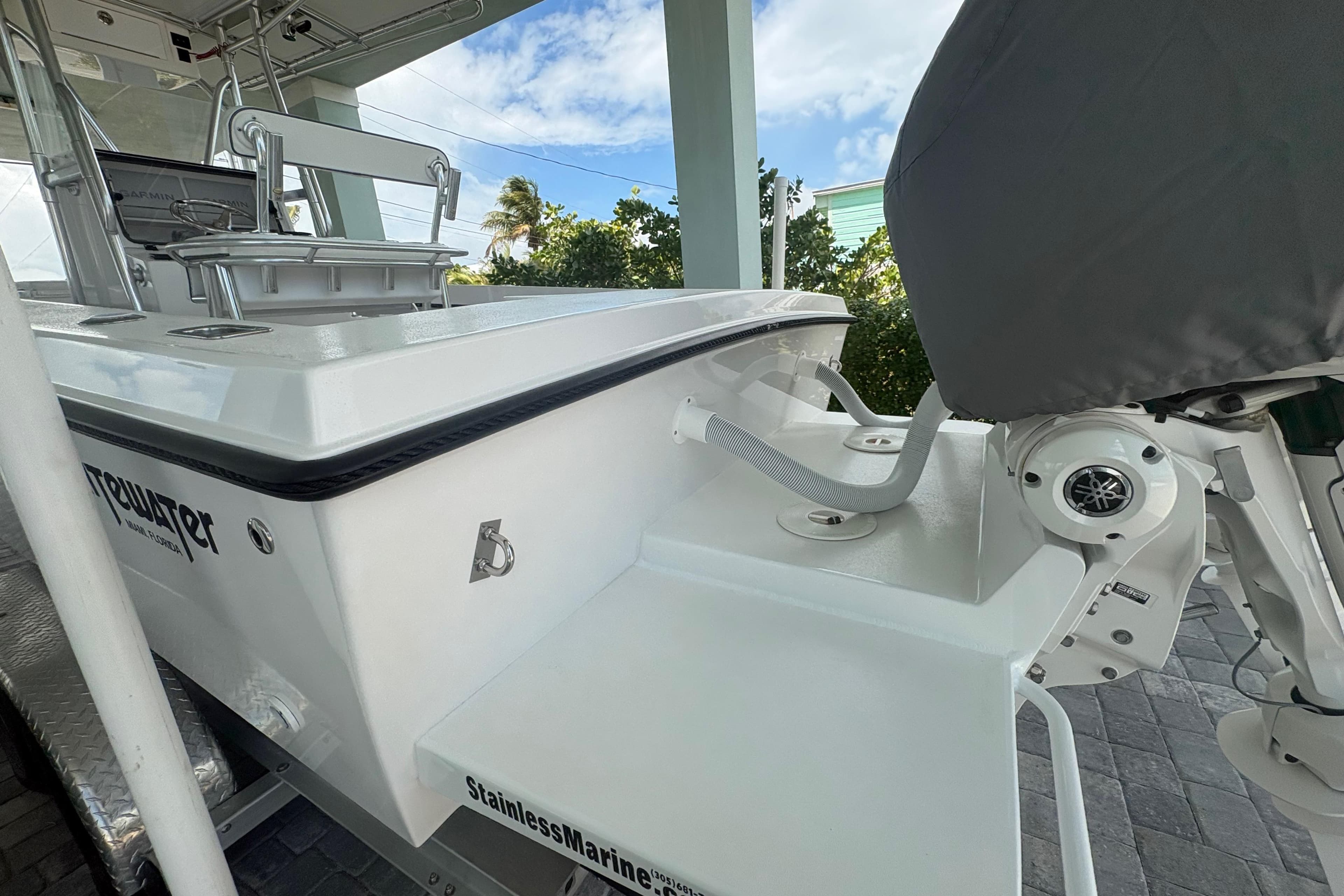 2025 Whitewater 28 boat with stainless marine features, docked under a clear sky.
