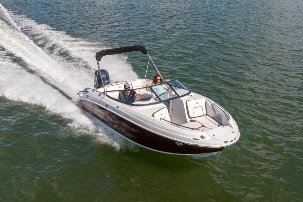 2027 Stingray 211 DC boat cruising on open water, showcasing sleek design and performance.