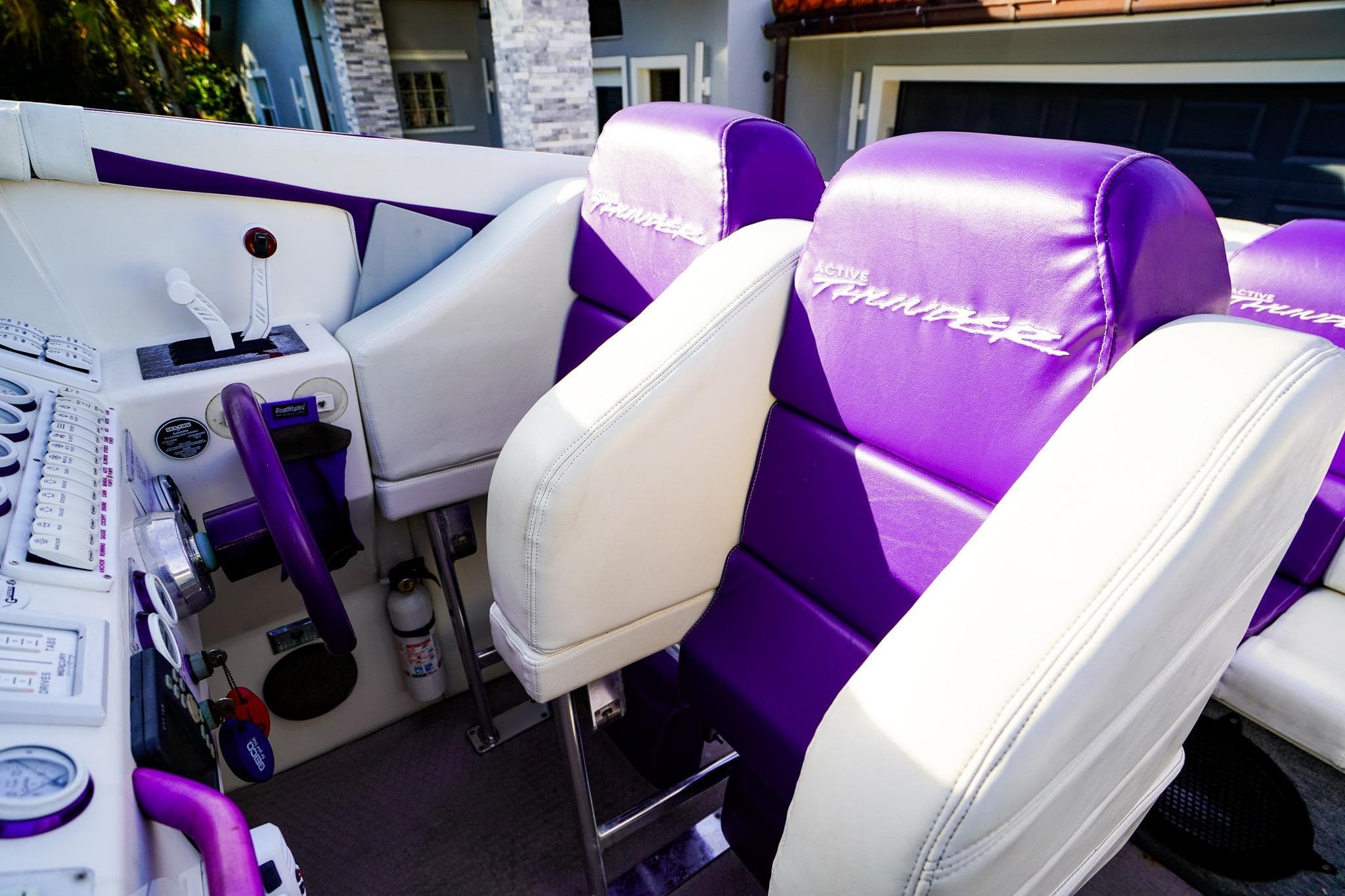 Interior of a 2000 Active Thunder 32 boat with purple and white seating.