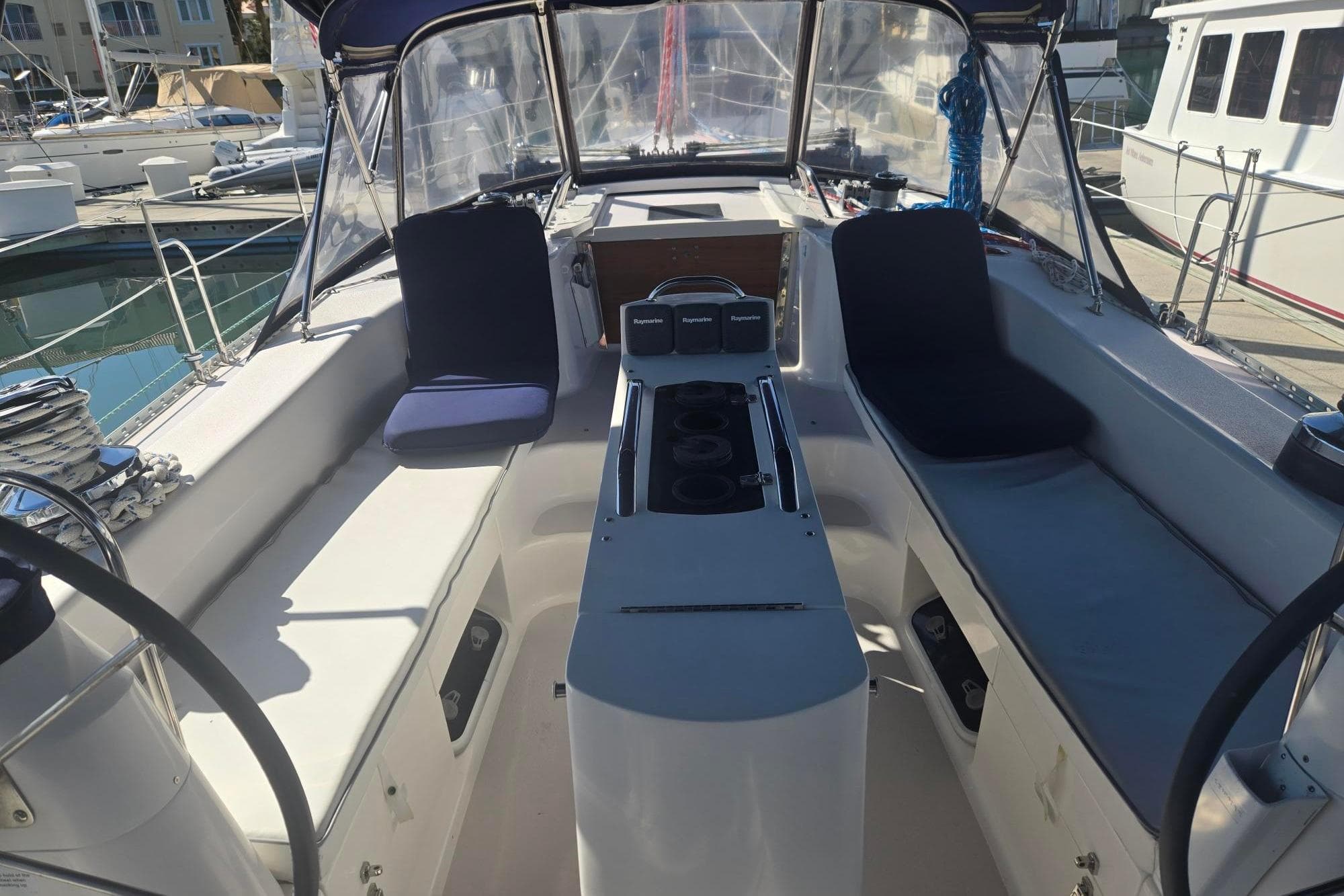 Cockpit of a 2000 Catalina 470 sailboat, featuring dual steering wheels and navigation equipment.