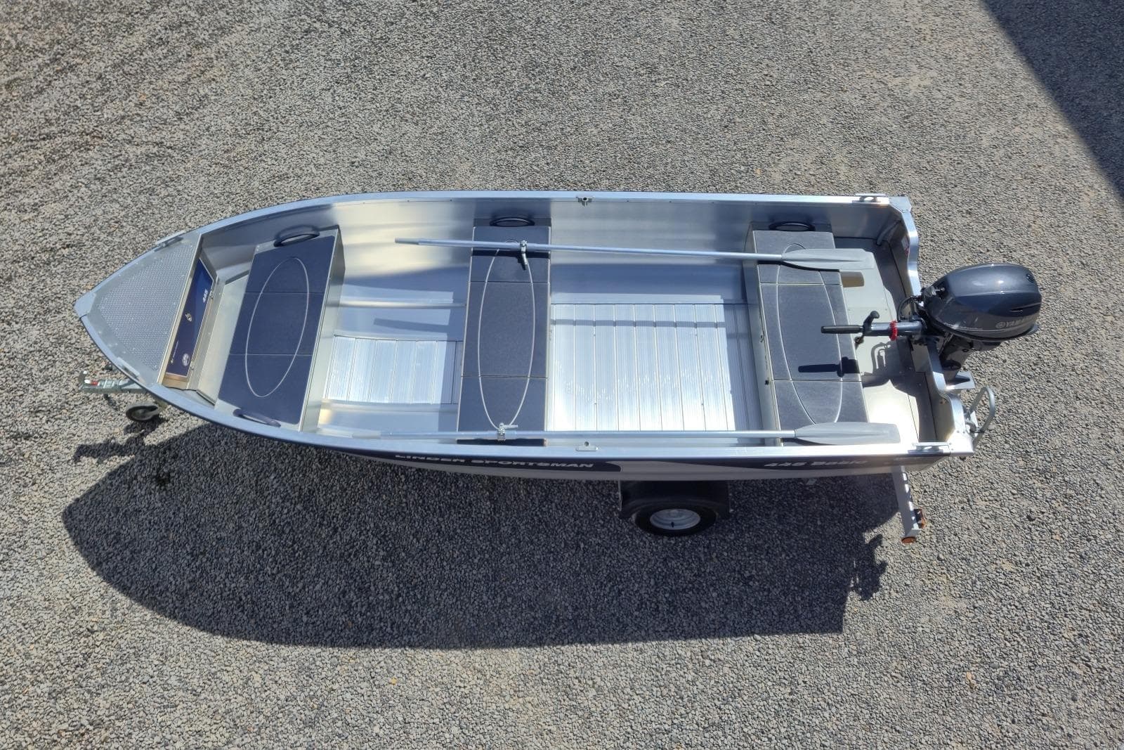 2026 Linder Sportsman 445 Basic boat on trailer, top view, gravel background.