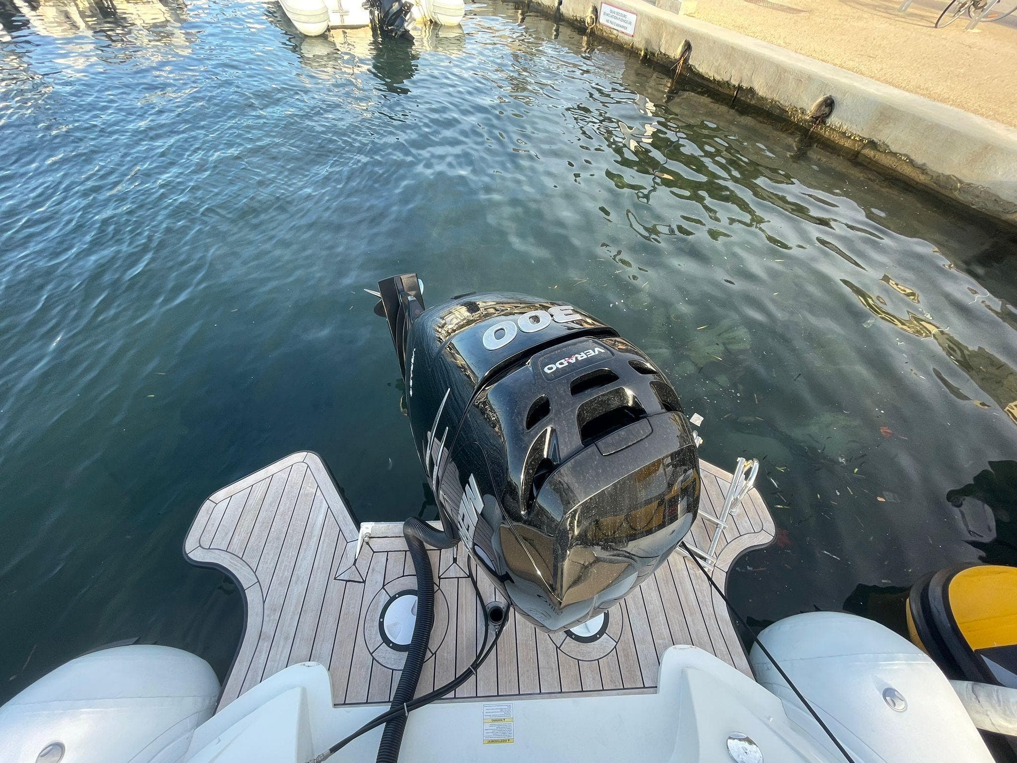 2016 SACS Strider 8 boat with outboard motor docked at marina.