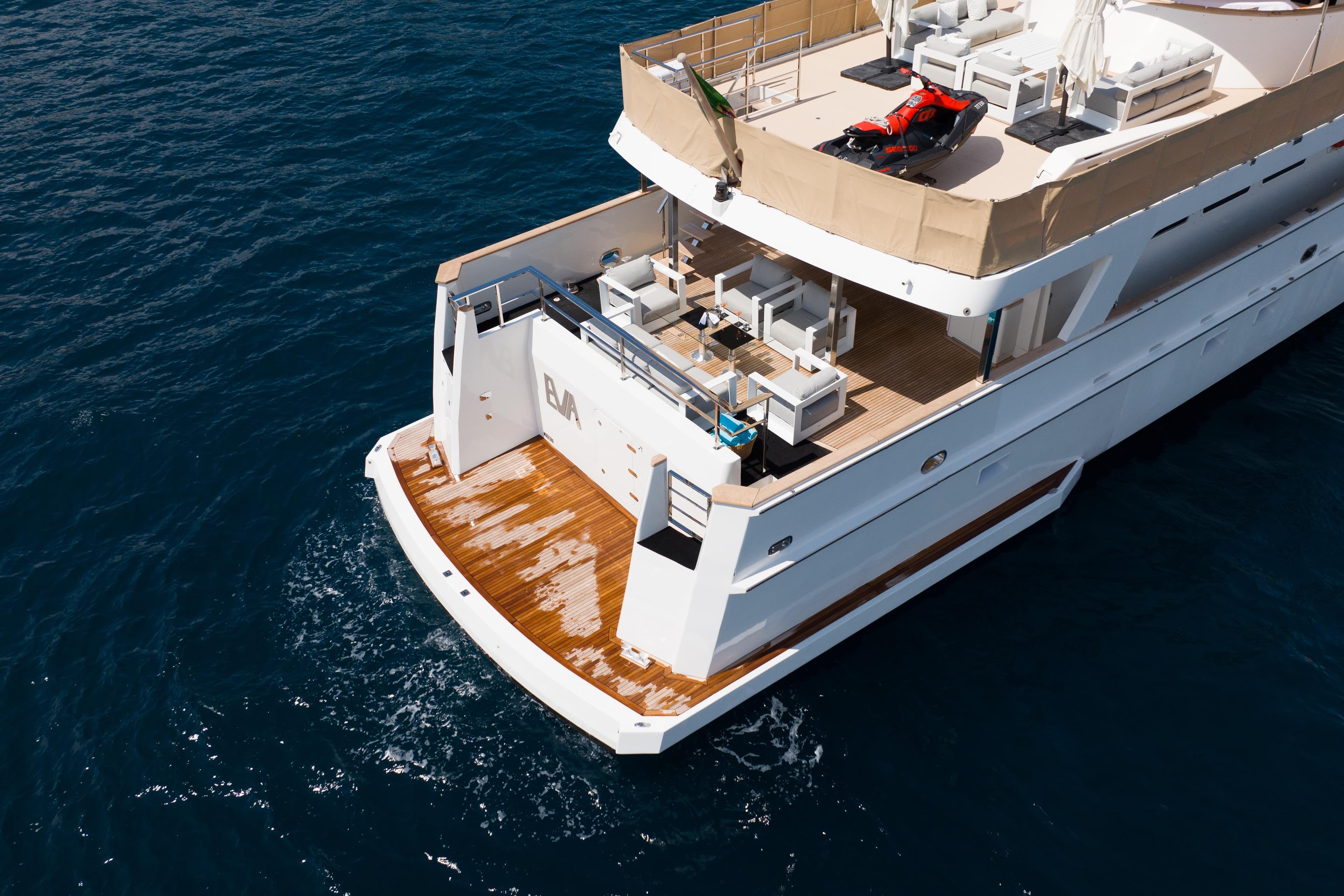 Luxury 1993 Cheoy Lee Custom yacht with spacious deck and watercraft, cruising on open sea.