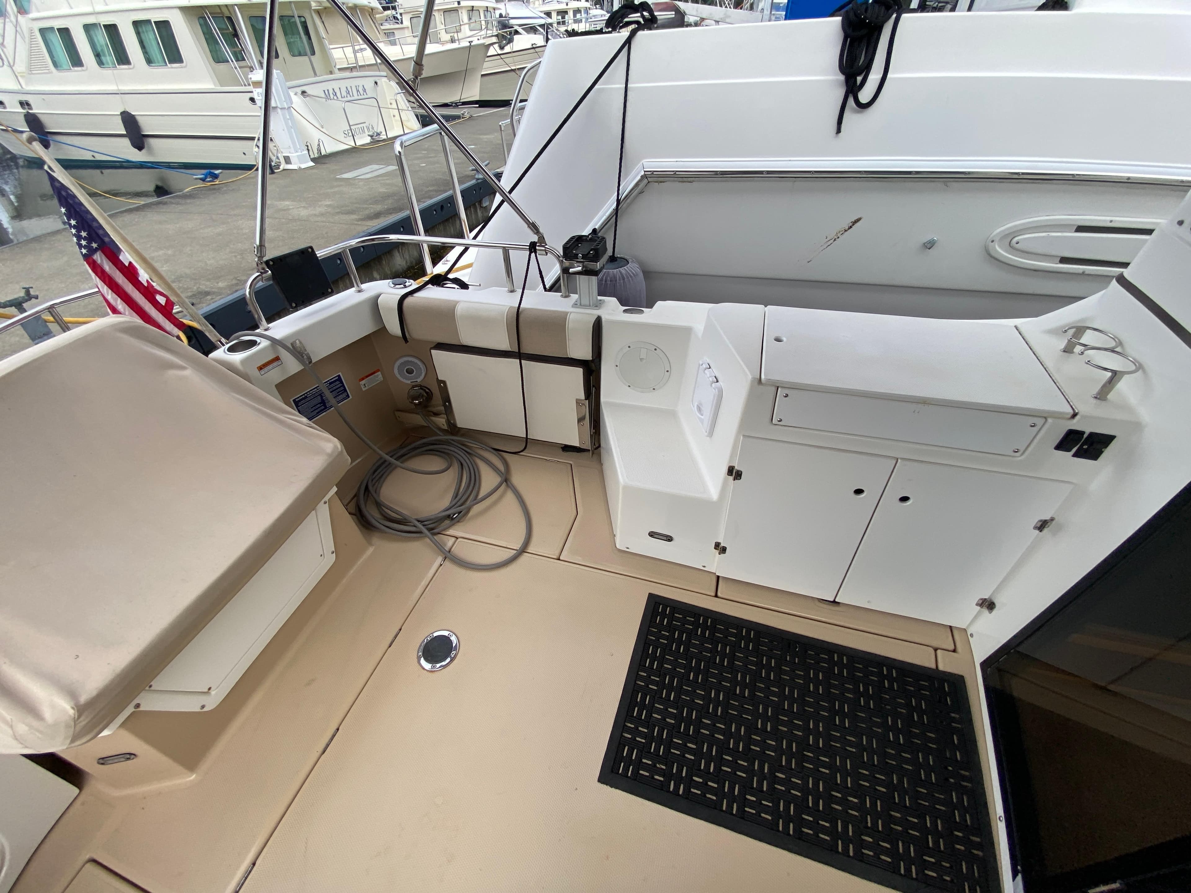 2015 Cutwater C-28 boat deck with storage compartments and American flag.