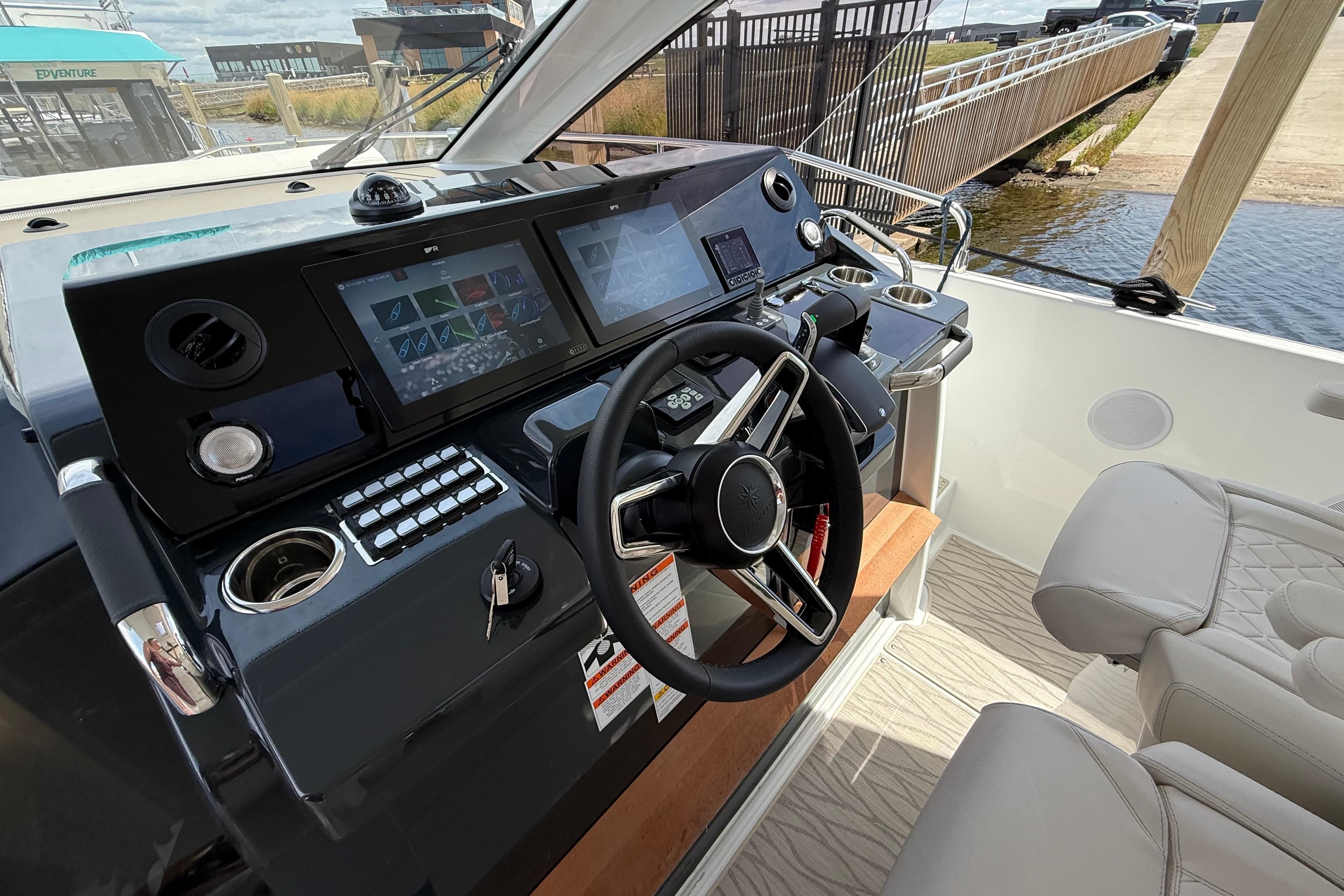 2026 Jeanneau DB/37 OB boat cockpit with modern steering and navigation controls.