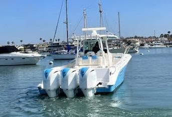 2018 HCB 39 Speciale boat with triple outboard engines in a marina setting.