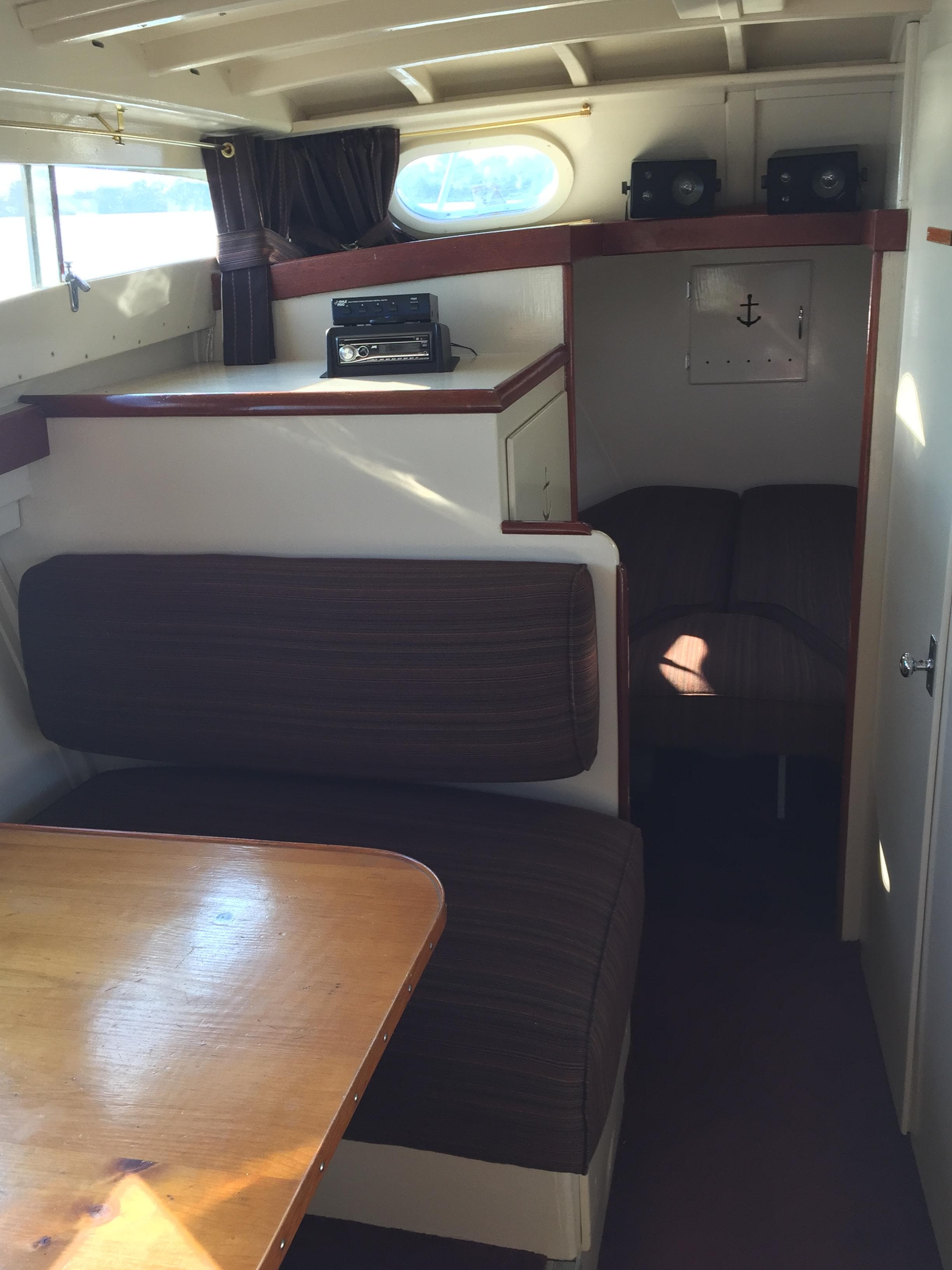 1954 Chris-Craft Commander interior with wood accents and cozy seating area.