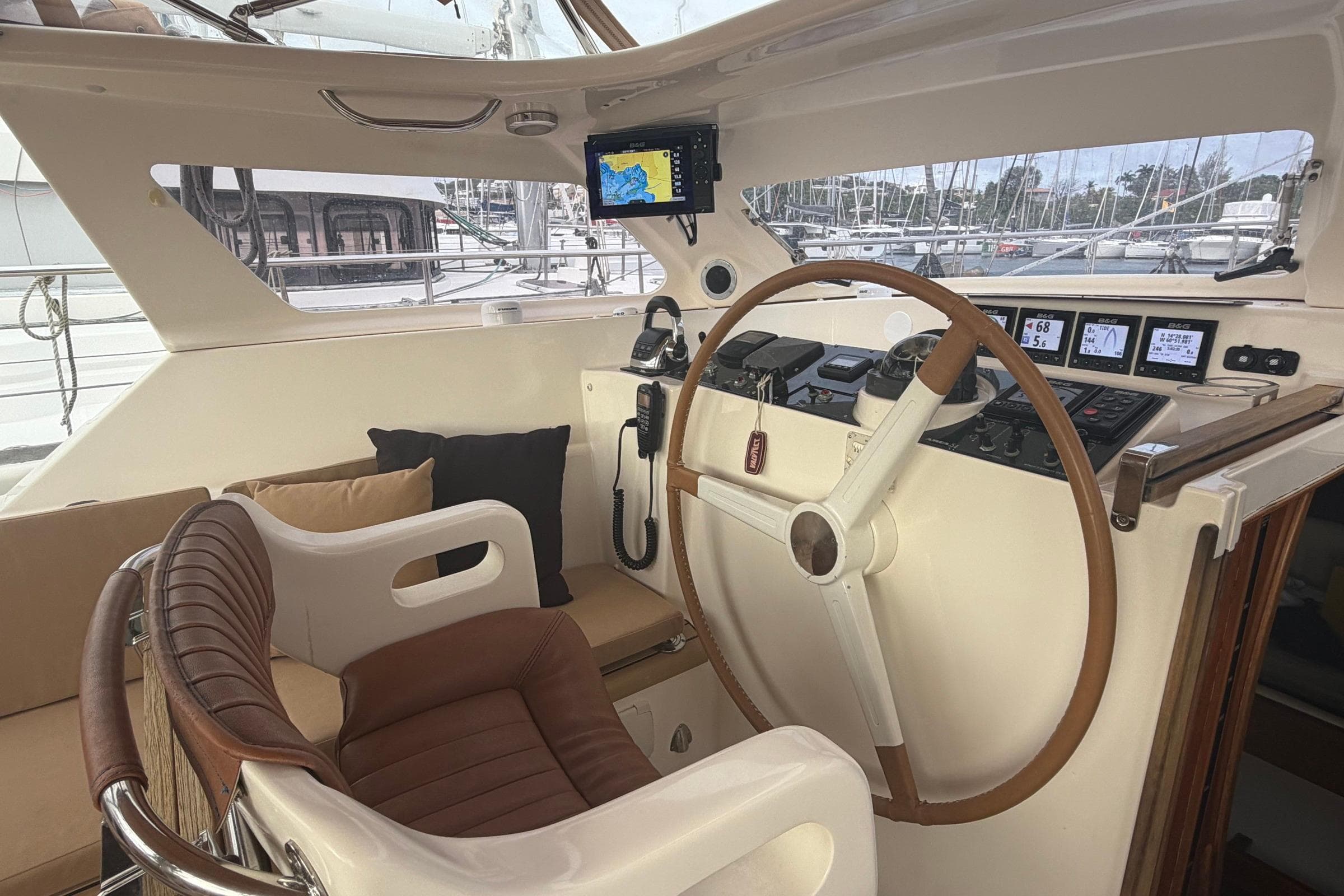 Cockpit of 2010 Amel 54 yacht with navigation equipment and steering wheel.