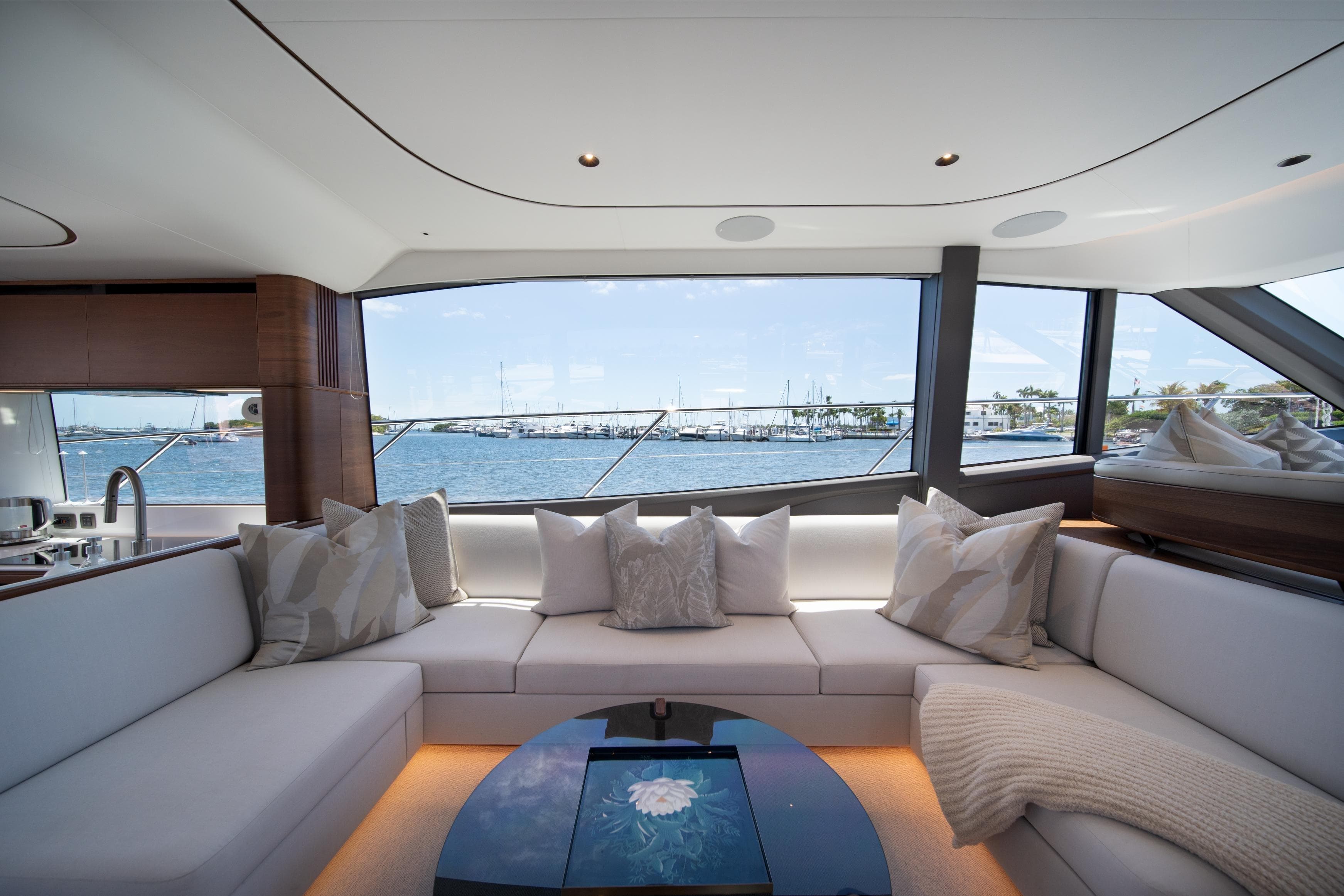 Luxurious interior of 2025 Princess F65 yacht with waterfront view and elegant seating.