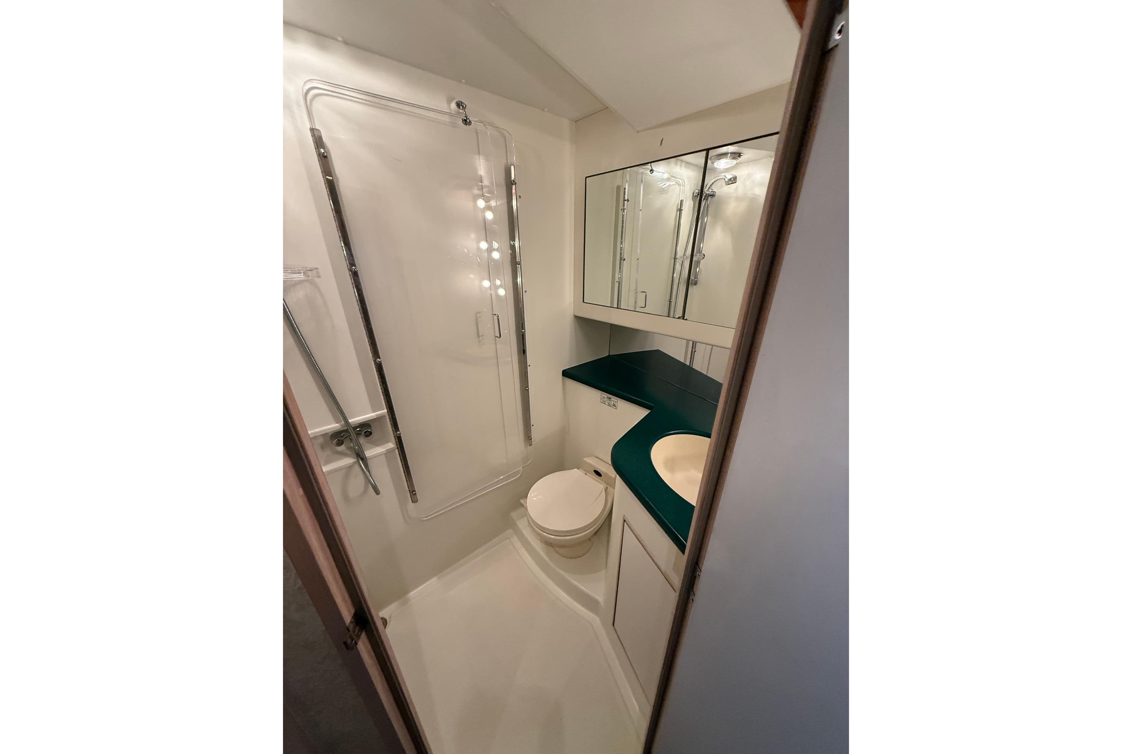Bathroom interior of 1994 Tollycraft 45 Cockpit Motor Yacht with shower and vanity.