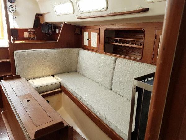 1977 Ontario Yachts 32 interior with wooden finish and cushioned seating.