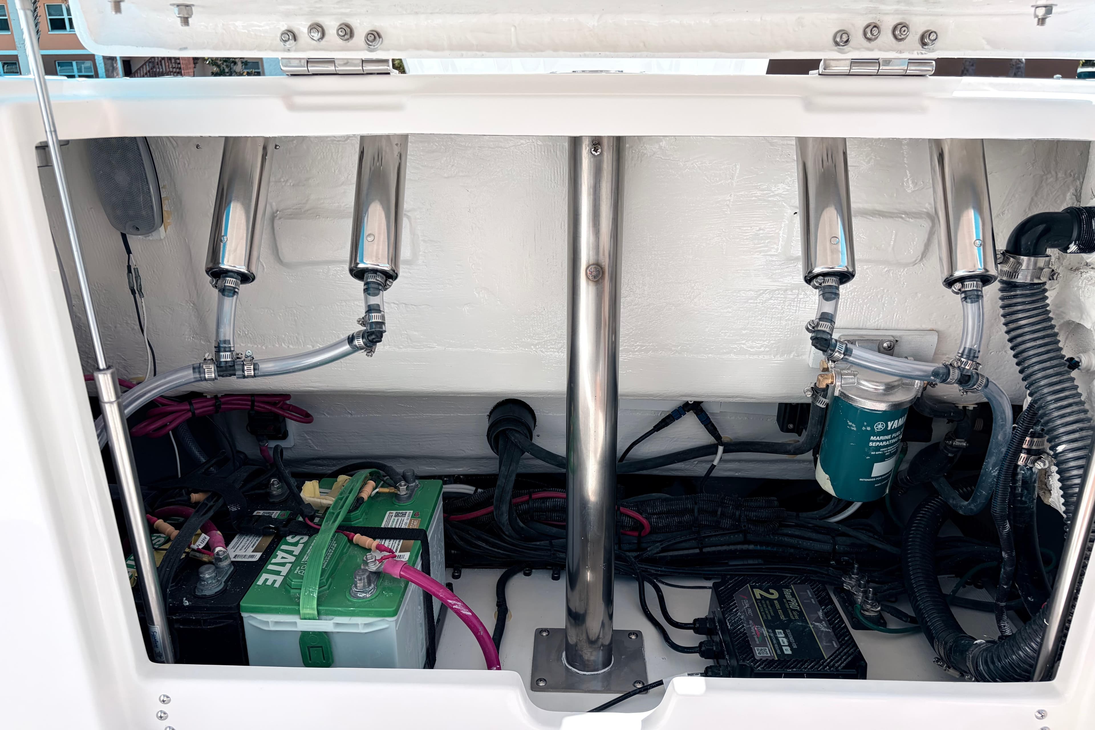 2026 Sailfish 252 CC boat engine compartment with batteries and wiring.