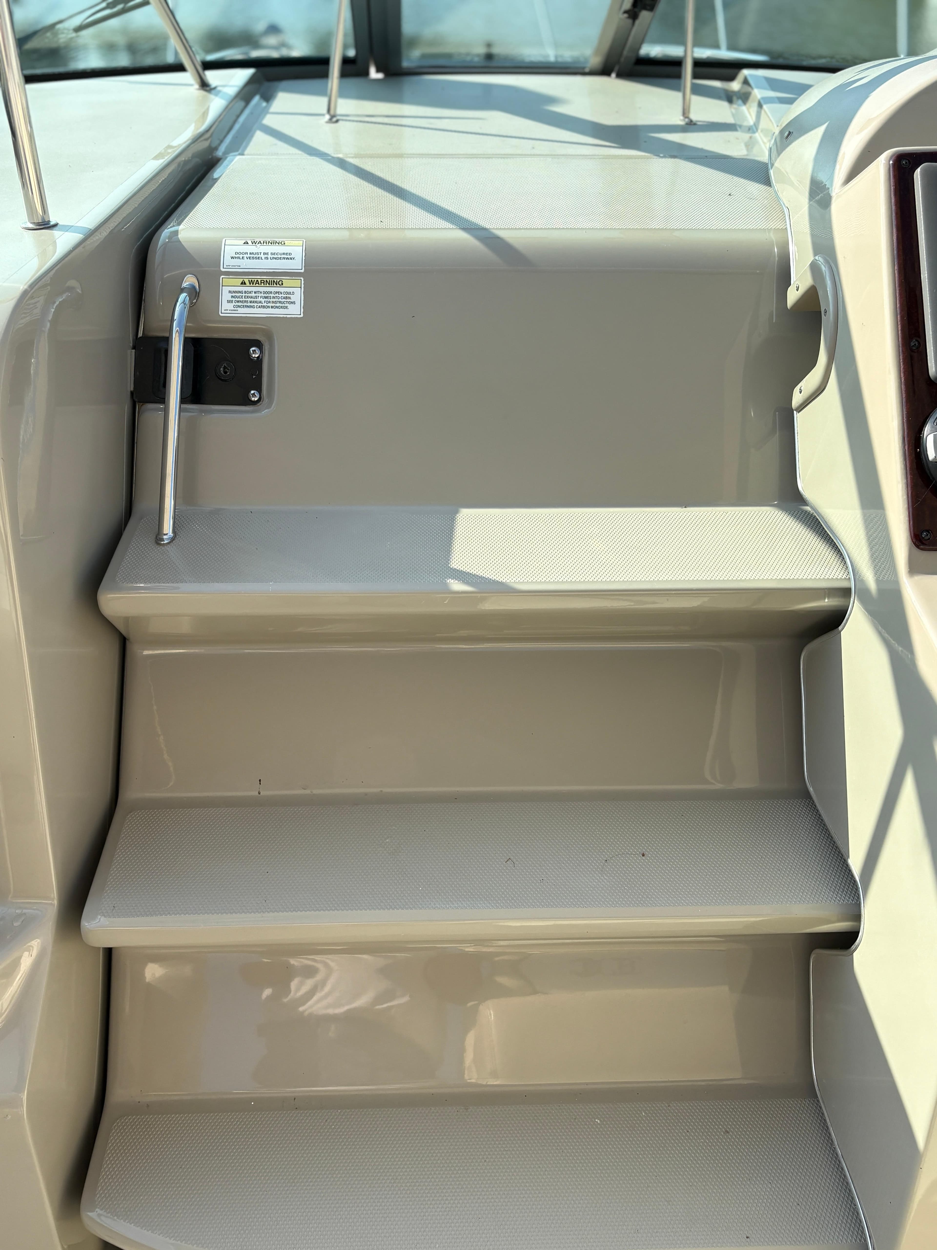 Stairs on a 2012 Sea Ray 350 Sundancer boat, featuring sleek design and metal handrails.