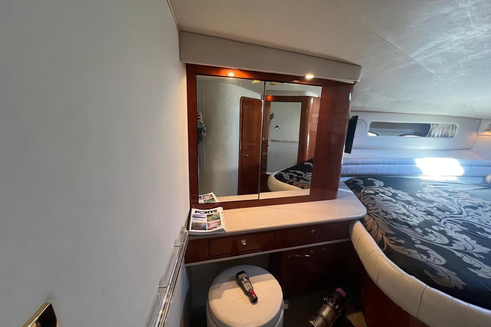Interior of 1997 Sea Ray 500 Sundancer yacht with elegant bedroom and vanity area.