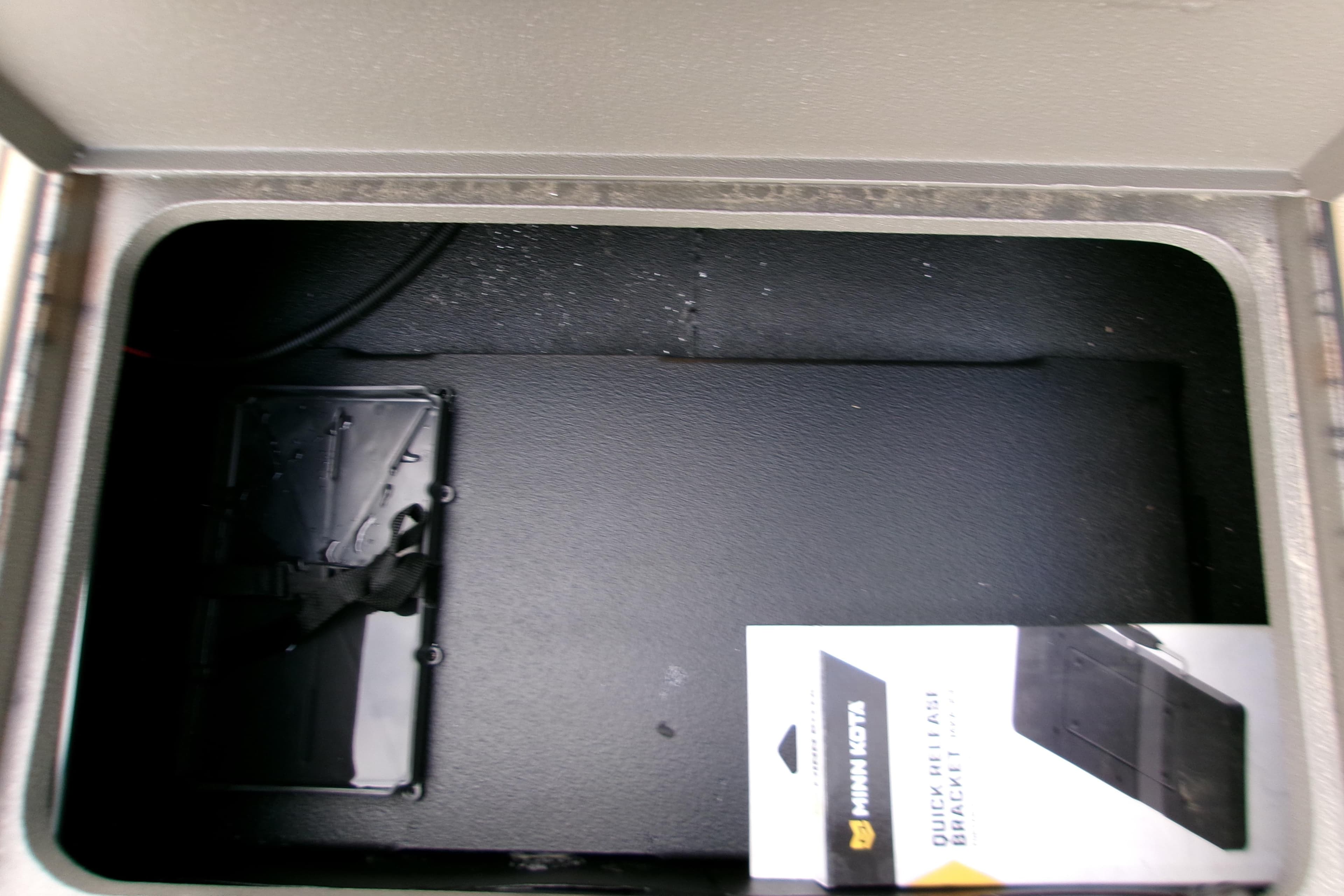 Storage compartment of 2026 Xpress Bayou 180CC with Minn Kota quick-release bracket.