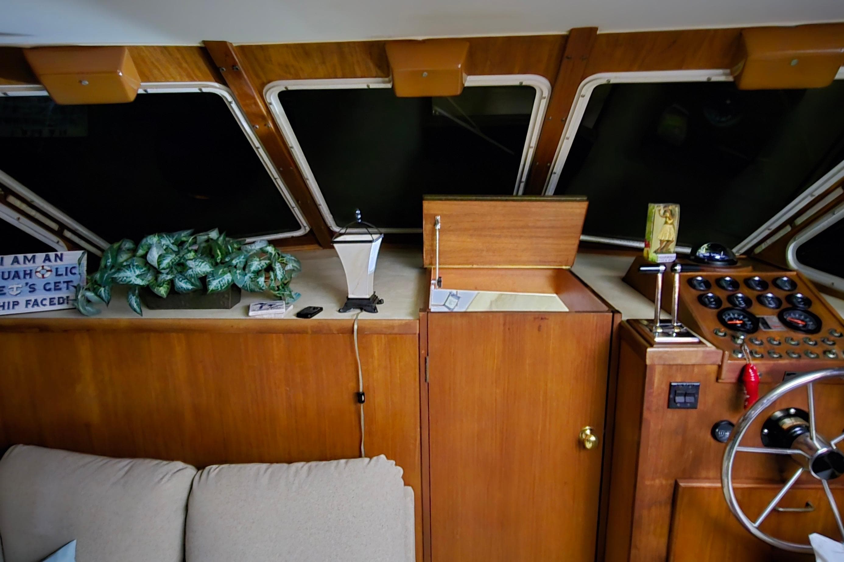 1986 Tollycraft 34 Sundeck interior with helm, gauges, and decor elements.