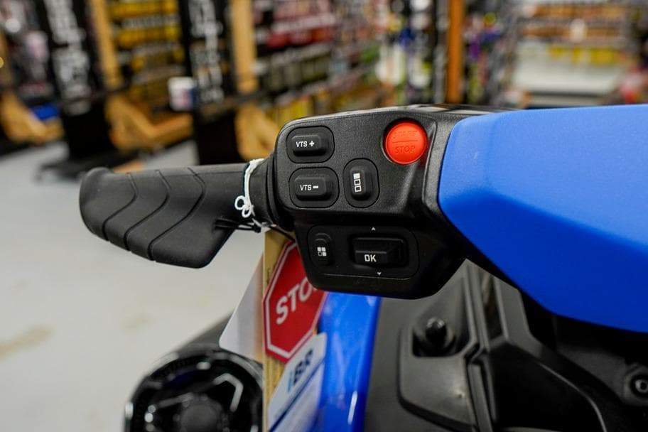 Close-up of 2026 Sea-Doo Wake Pro 230 handlebar controls in a showroom.