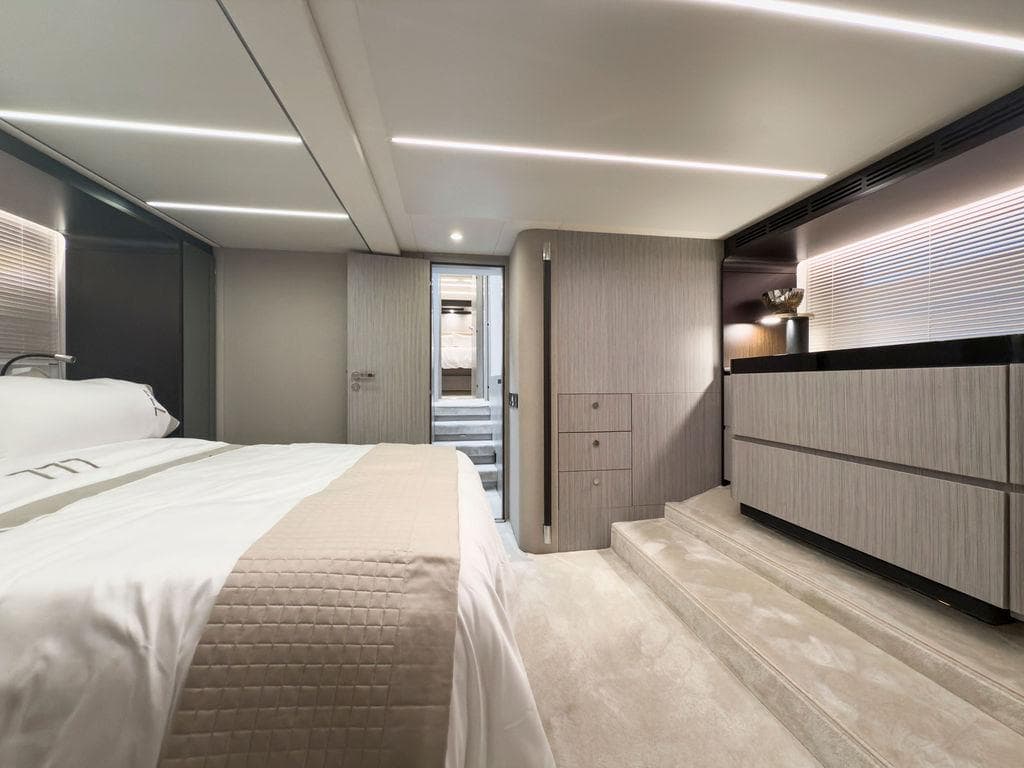 Luxurious bedroom interior of 2020 Azimut 66 yacht, featuring modern design and elegant furnishings.