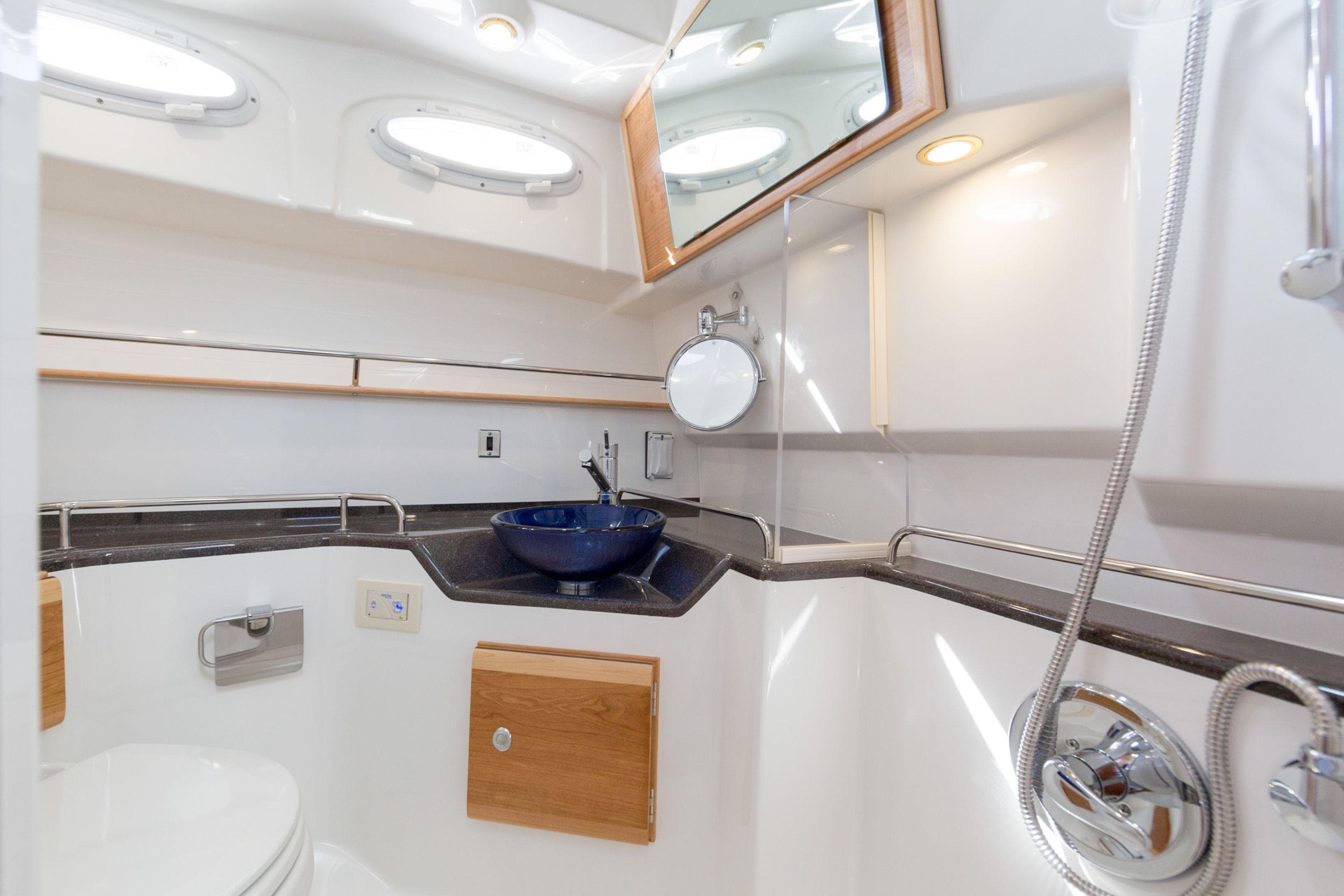 Luxurious bathroom interior of 2026 Cutwater C-32 Coupe yacht with modern fixtures.
