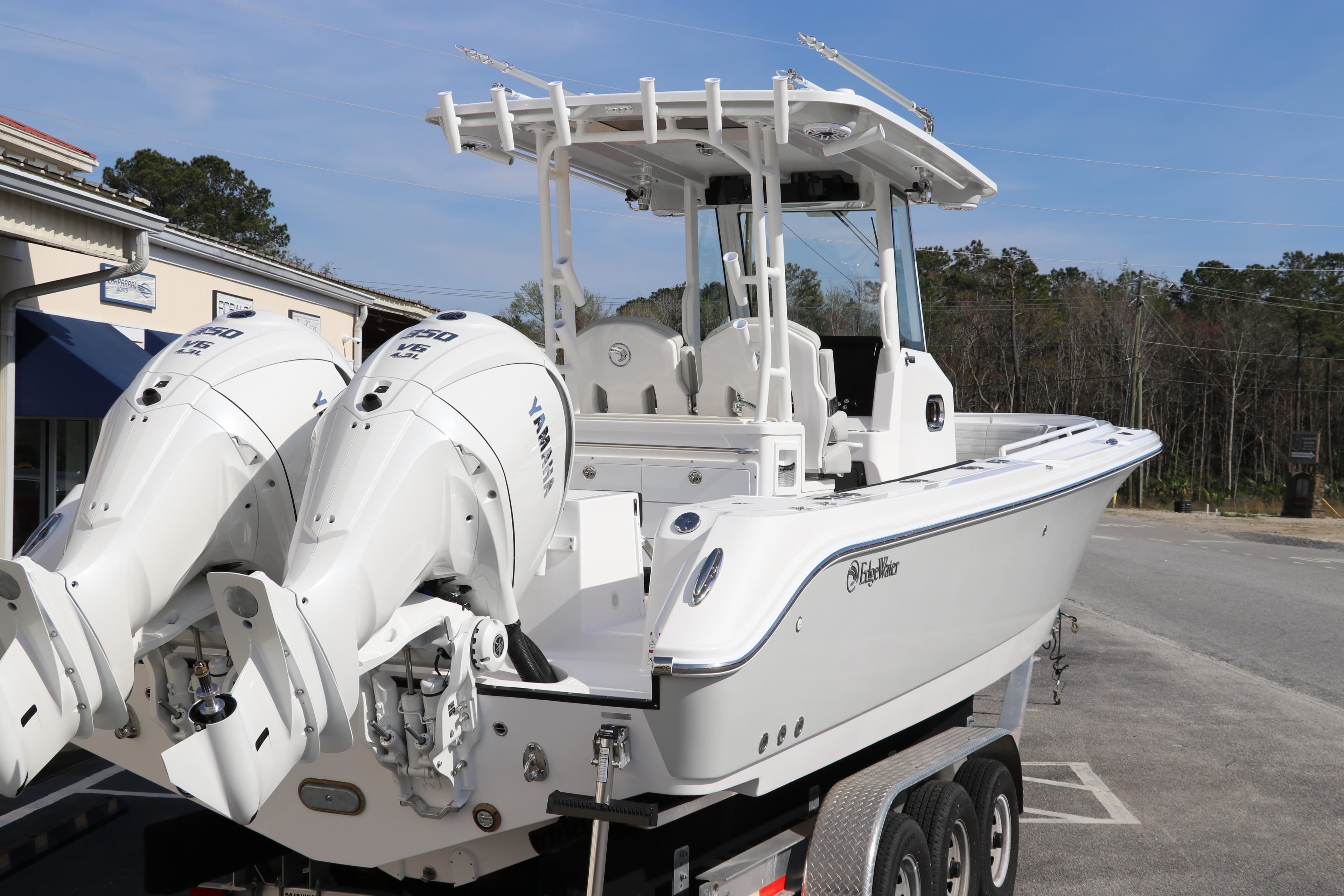 2025 Edgewater 325CC boat with dual Yamaha engines on a trailer.