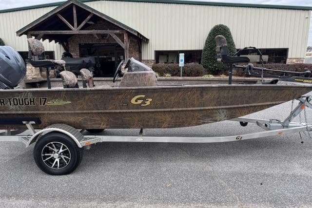 2023 G3 Gator Tough 17 SC boat on trailer, parked outside a building.