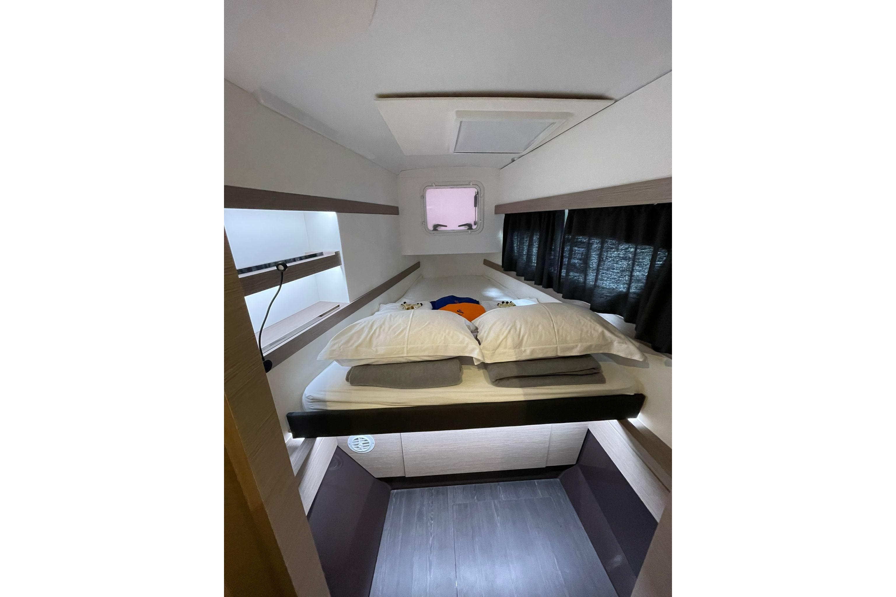Interior cabin of 2022 Fountaine Pajot Isla 40 catamaran, featuring a cozy bed and modern design.